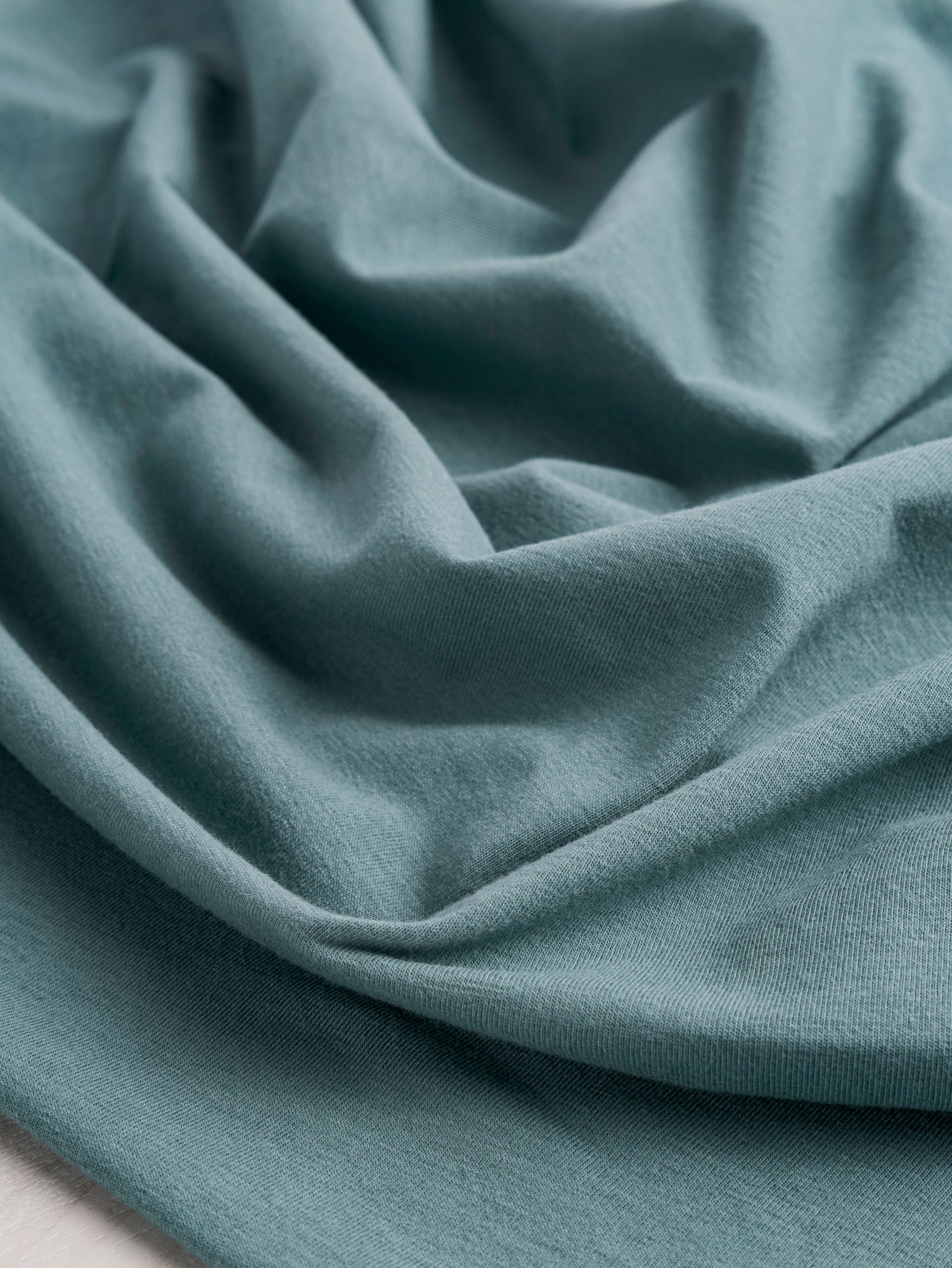 F-DEA085-003-Midweight-Organic-Cotton-Spandex-Jersey-Knit-Deadstock-Teal-Core-Fabrics-scrunched.JPG