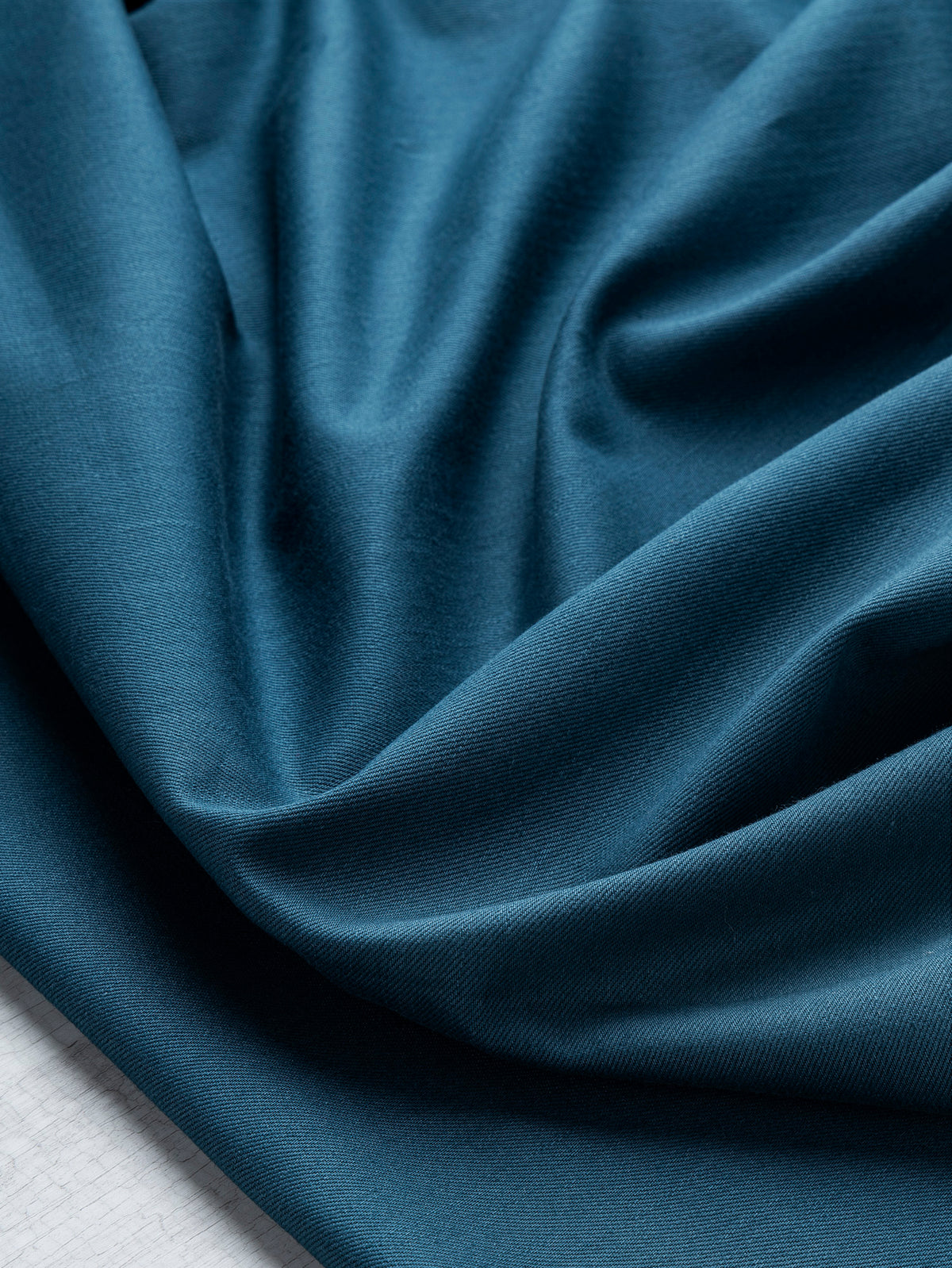F-DEN022-009-10oz-Organic-Cotton-Stretch-Bull-Denim-Dark-Teal-Core-Fabrics-scrunched.webp