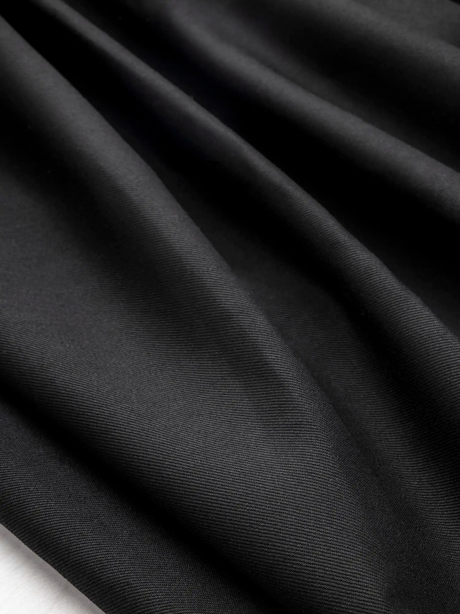 F-DEN039-12oz-Non-Stretch-Cotton-Tencel-Cone-Denim-Black-Core-Fabrics-scrunched.webp