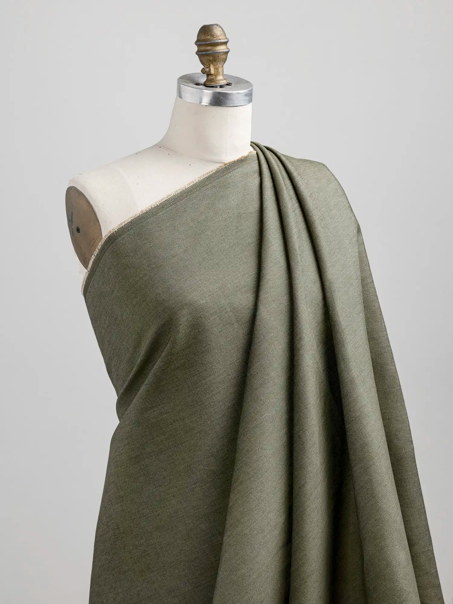 F-COT453-7-6-oz-Recycled-Cotton-Denim-Olive-Core-Fabrics-draped.webp