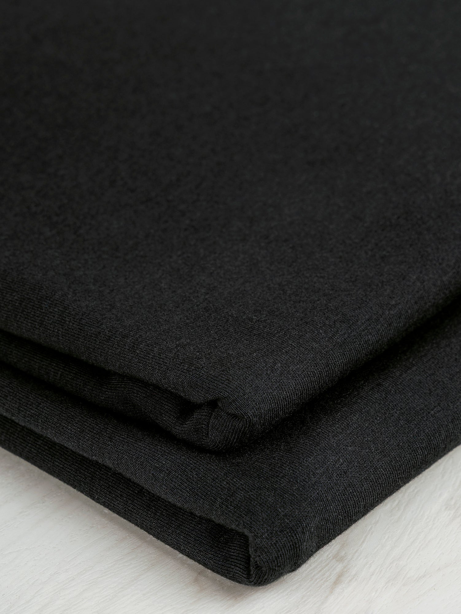 F-BAM006-001-Bamboo-Organic-Cotton-Spandex-Jersey-Knit-Black-Core-Fabrics-fold.JPG