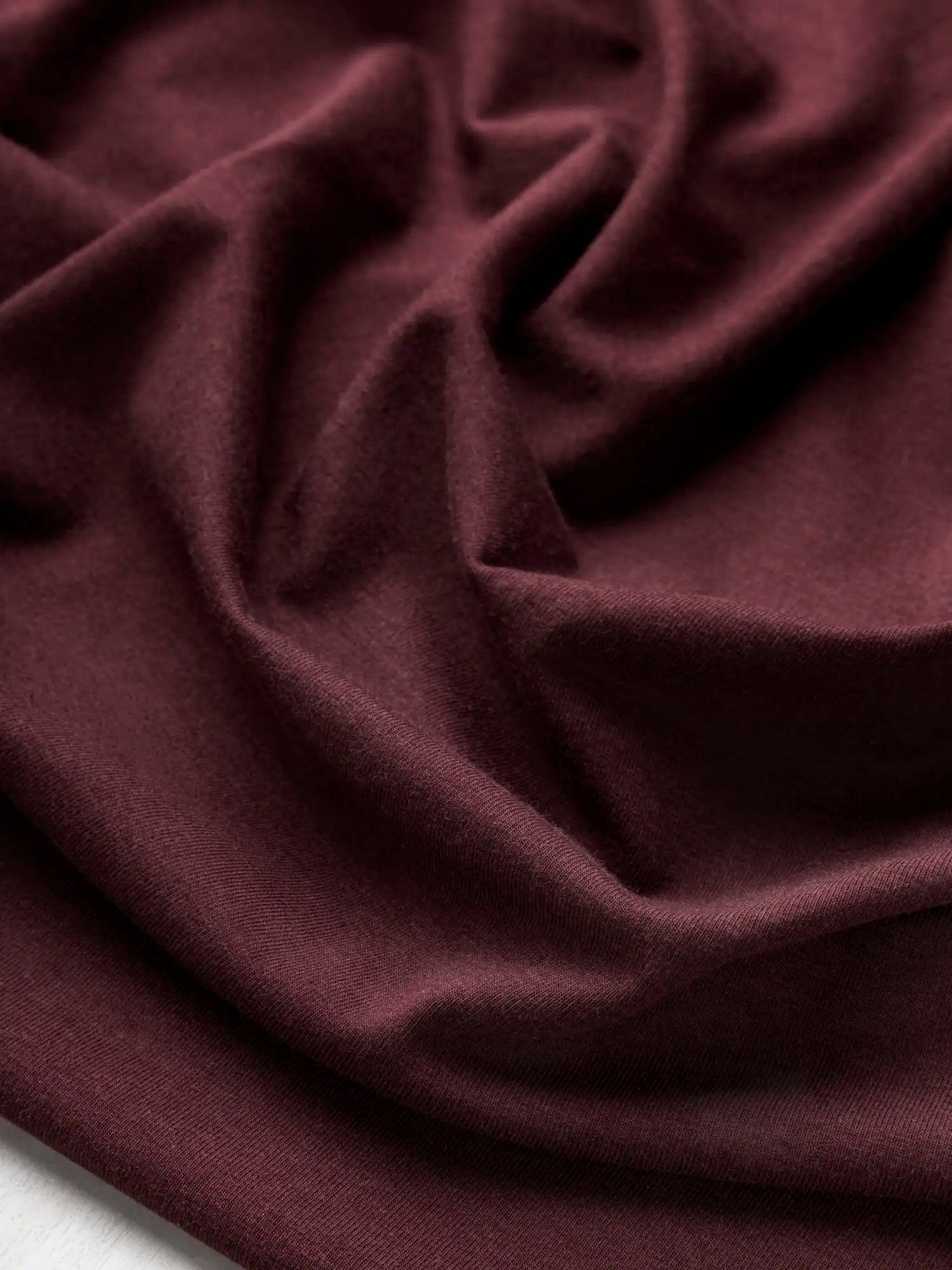 F-BAM006-014-Bamboo-Organic-Cotton-Spandex-Jersey-Knit-Bordeaux-Core-Fabrics-scrunched.webp