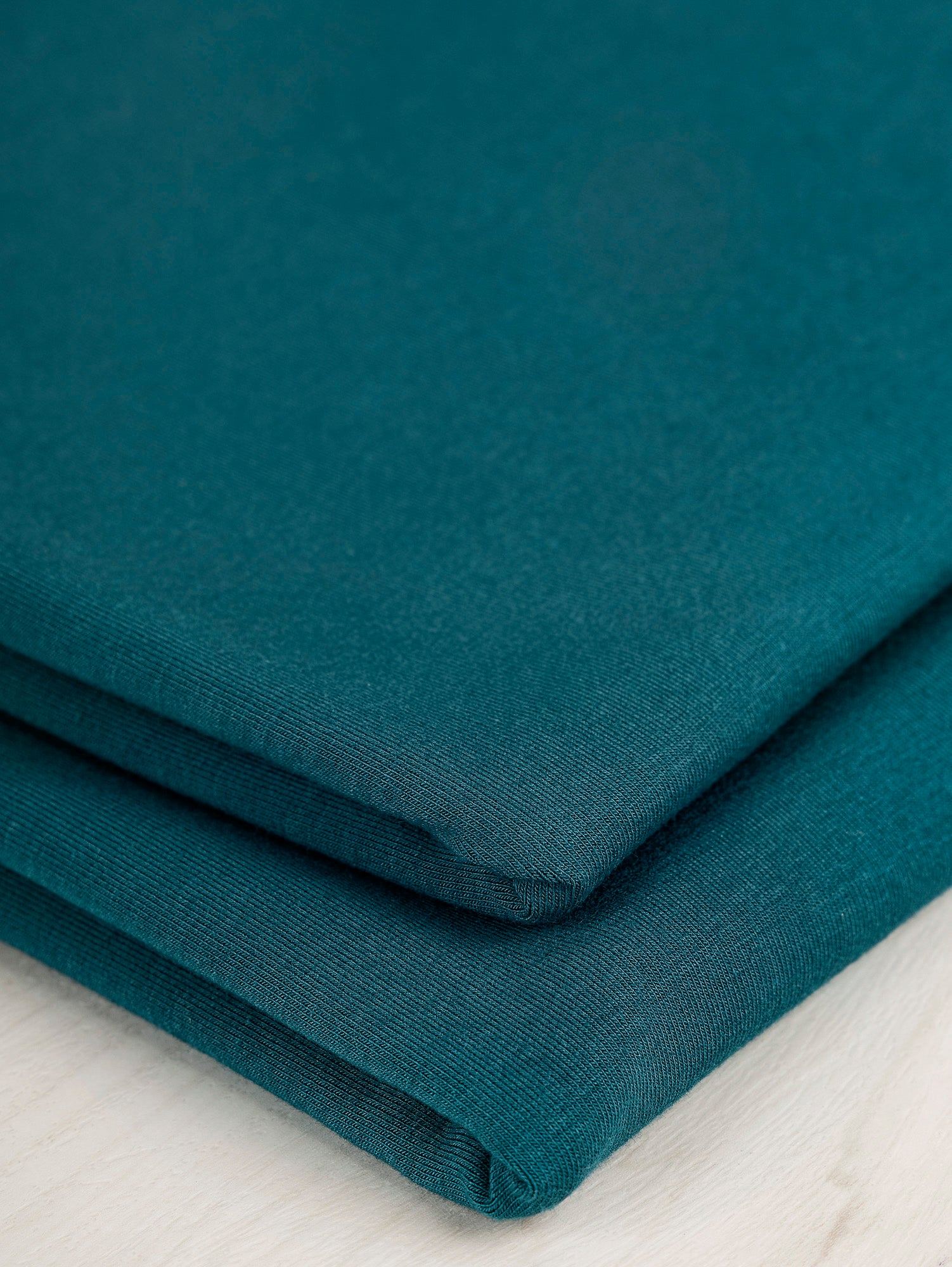 F-BAM006-021-Bamboo-Organic-Cotton-Spandex-Jersey-Knit-Teal-Core-Fabrics-fold.JPG