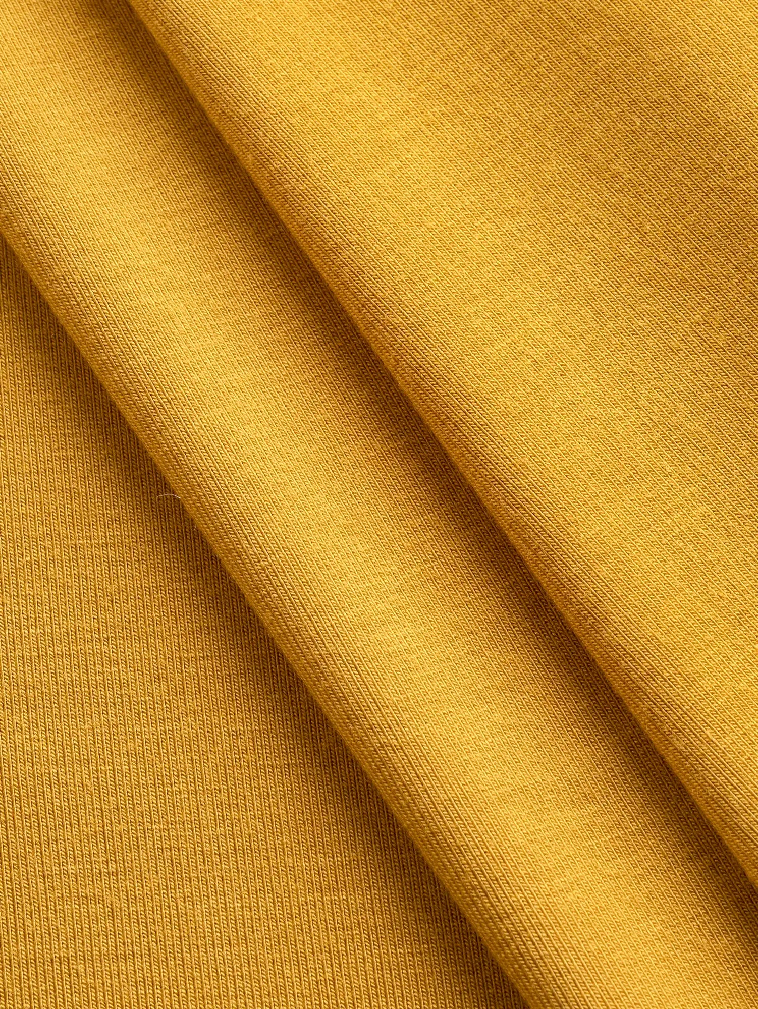 F-DEA239-Bamboo-Rayon-Spandex-Stretch-Knit-Deadstock-Mustard-Core-Fabrics-fold.webp