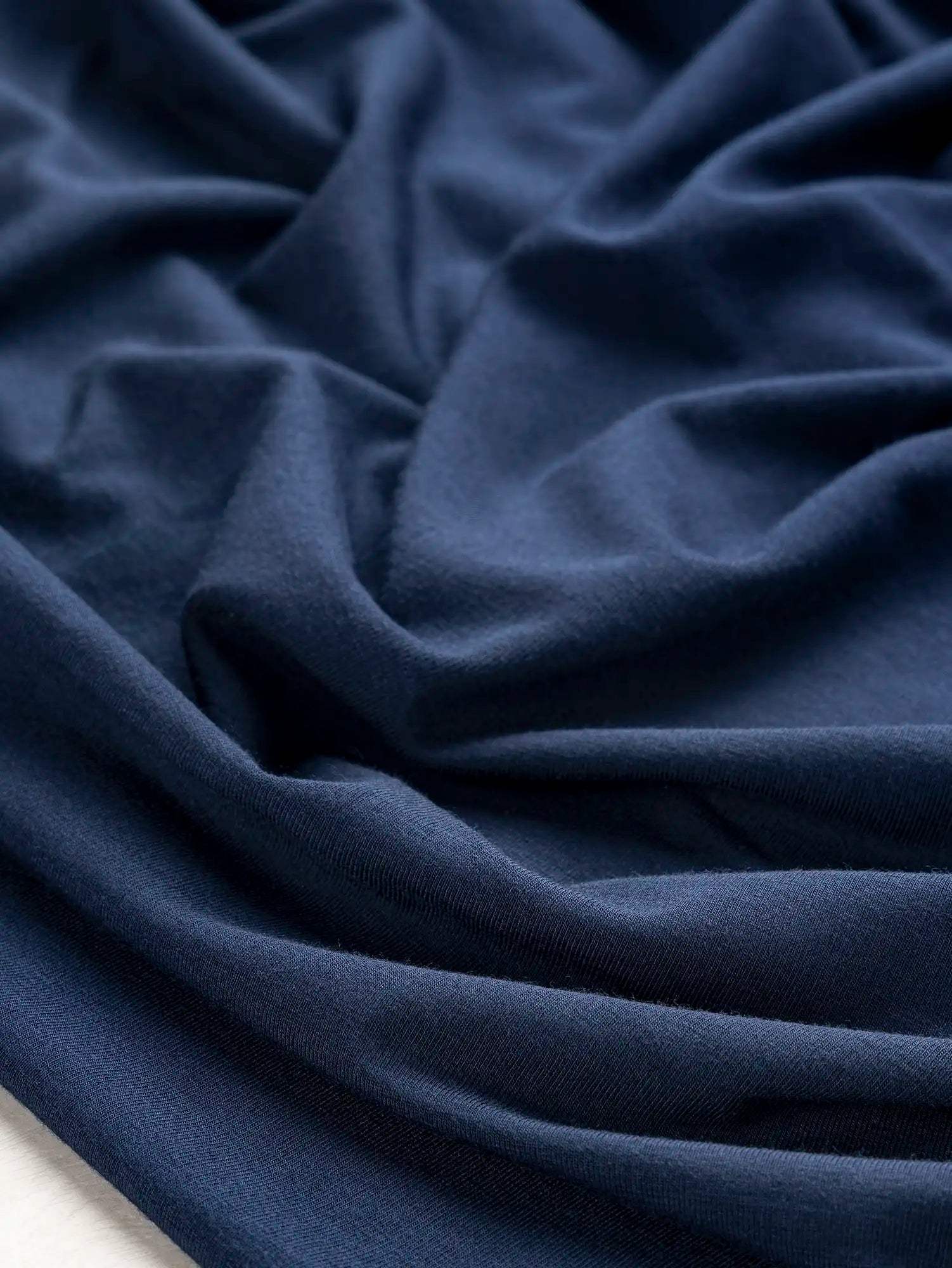 F-DEA206-Bamboo-Spandex-Stretch-Knit-Deadstock-Midnight-Blue-Core-Fabrics-scrunched.webp