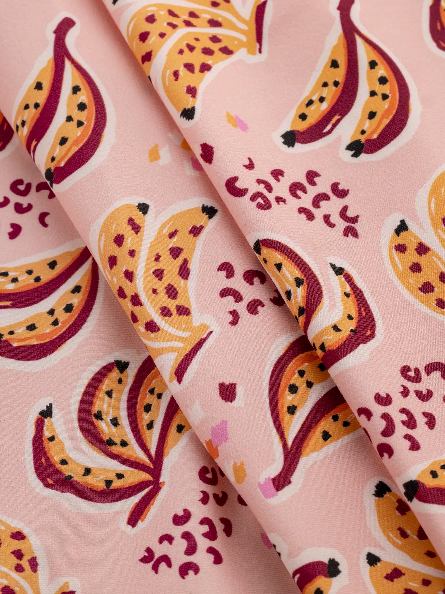 F-NYL021-Banana-Split-Print-Swim-Performance-Knit-Pink-and-Multicolour-Core-Fabrics-fold.webp