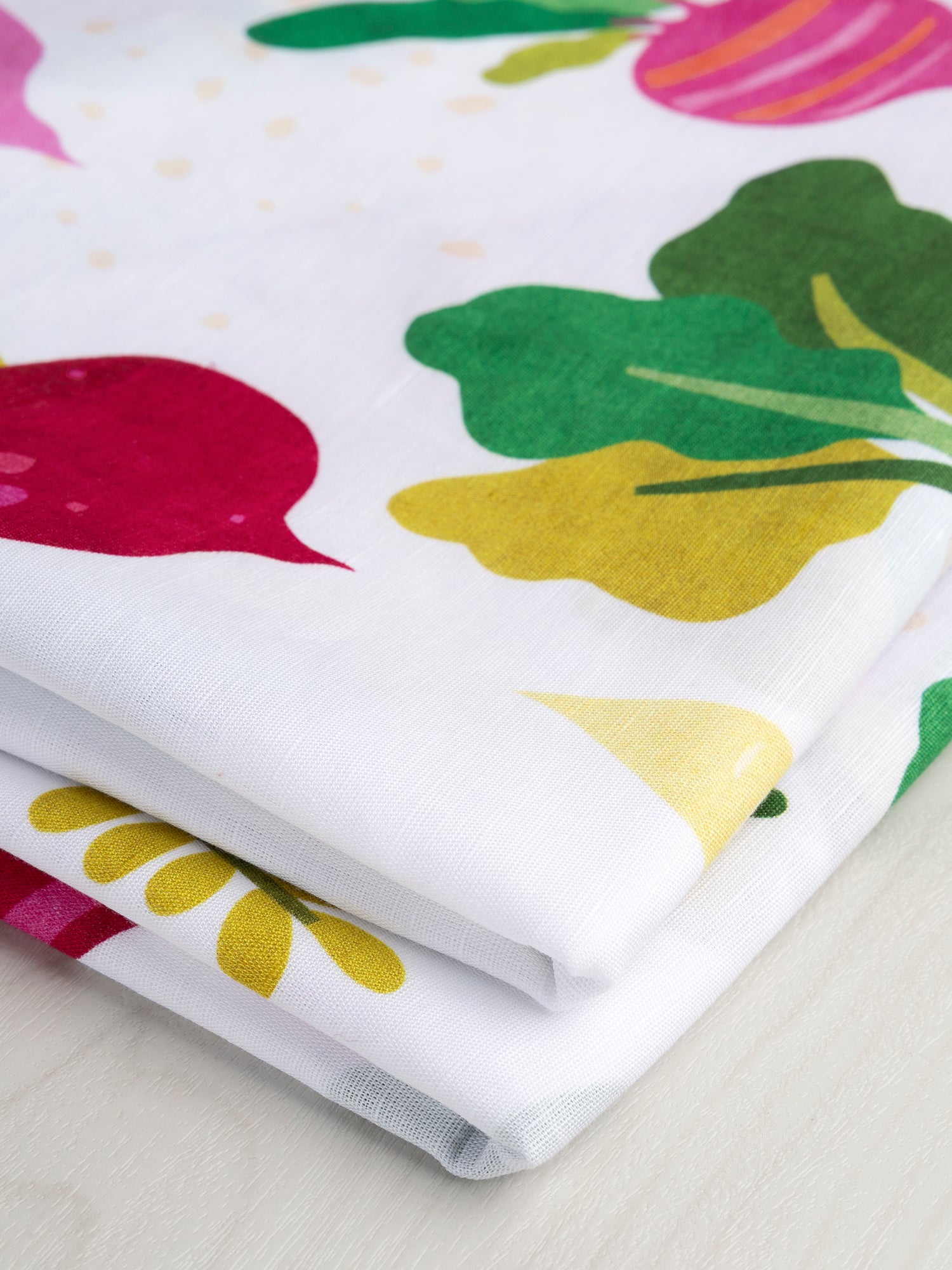 F-COT355-Beet-It-Print-Organic-Cotton-Linen-White-Green-Magenta-Core-Fabrics-fold.JPG