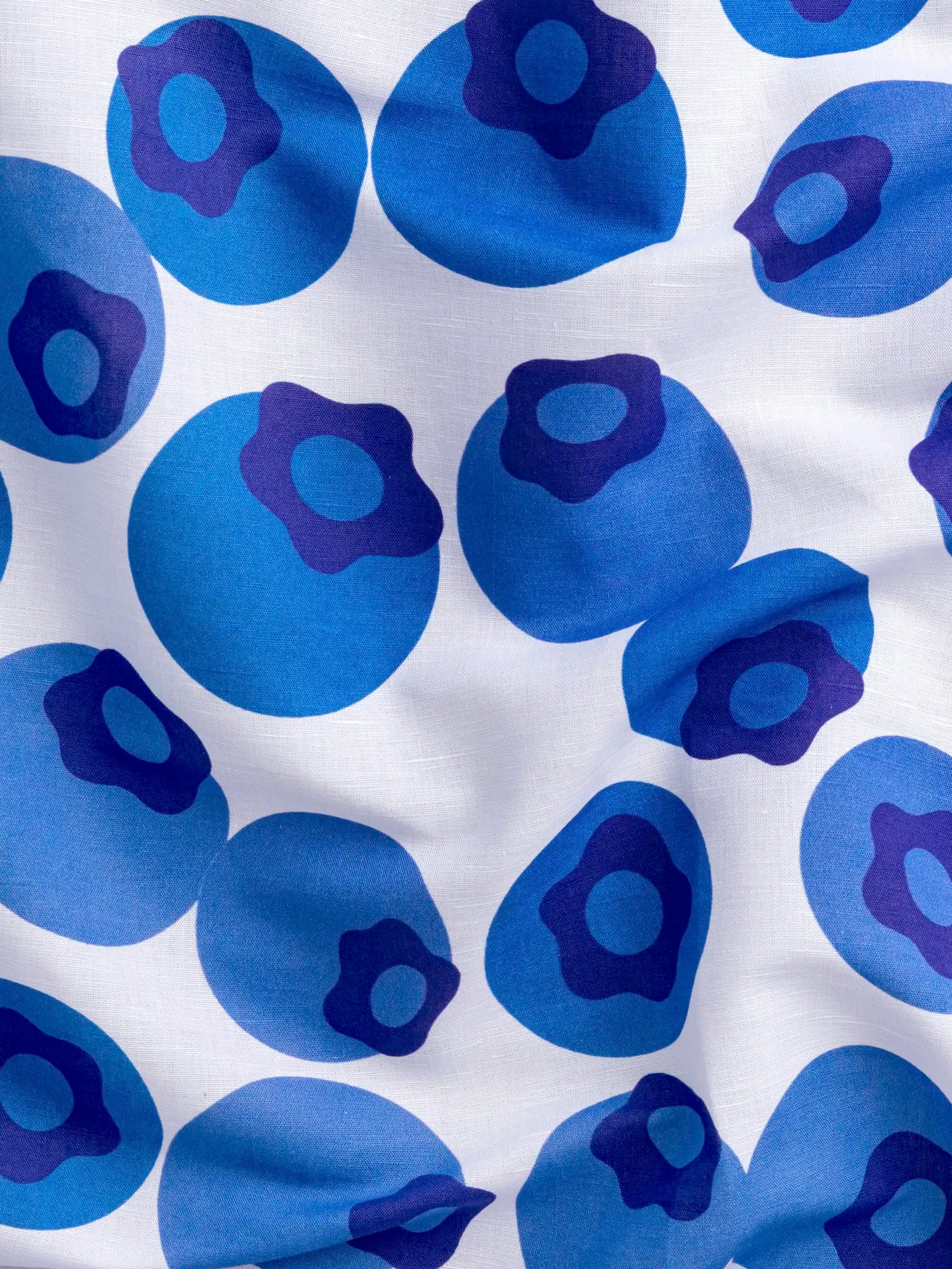 F-COT467-Blueberry-Blowup-Print-Organic-Cotton-Linen-White-and-Blue-Violet-Core-Fabrics-scrunched.webp