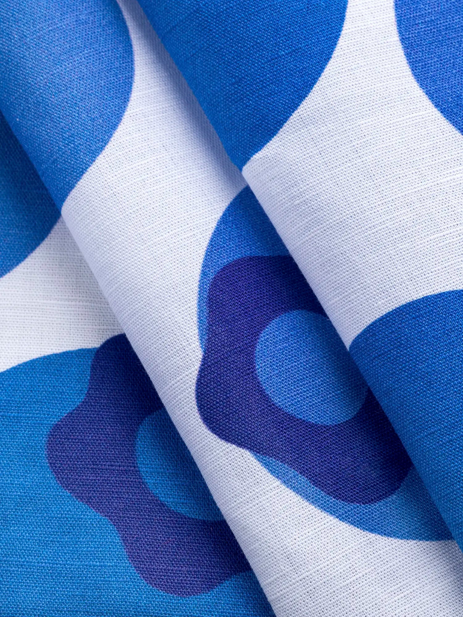 F-COT467-Blueberry-Blowup-Print-Organic-Cotton-Linen-White-and-Blue-Violet-Core-Fabrics-fold.webp