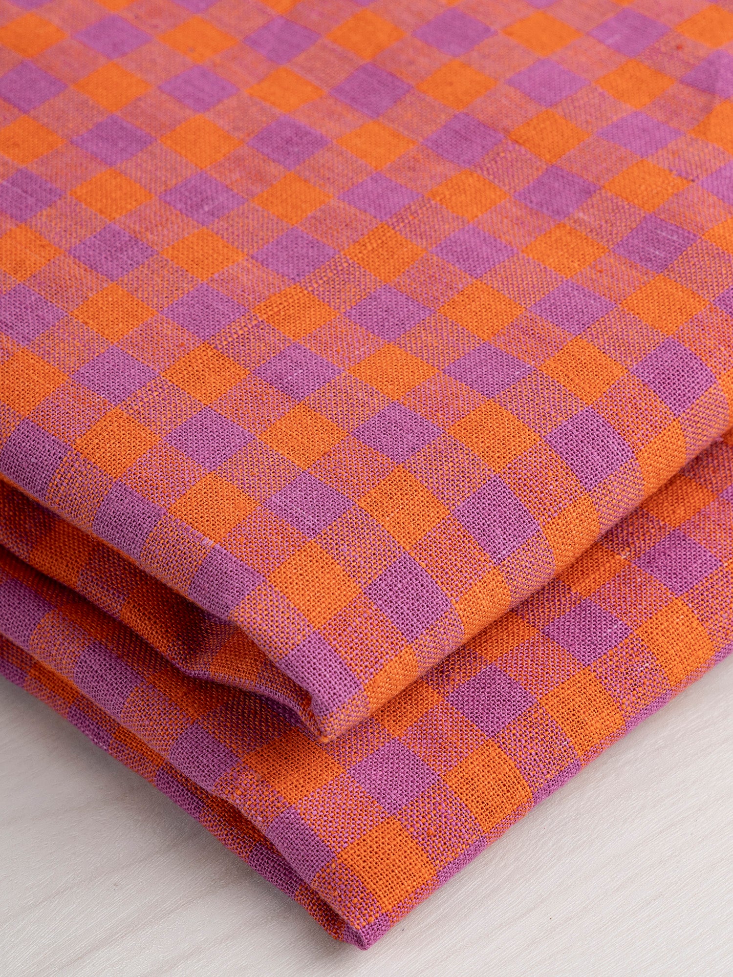 F-COT372-002-Breezy-Handwoven-Gingham-Cotton-Flame-and-Violet-Core-Fabrics-fold