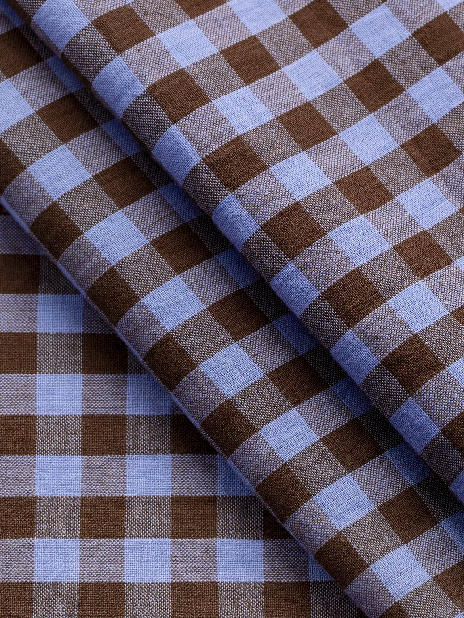 F-COT372-004-Brownie-Handwoven-Gingham-Cotton-Chocolate-and-Cornflower-Core-Fabrics-fold.webp