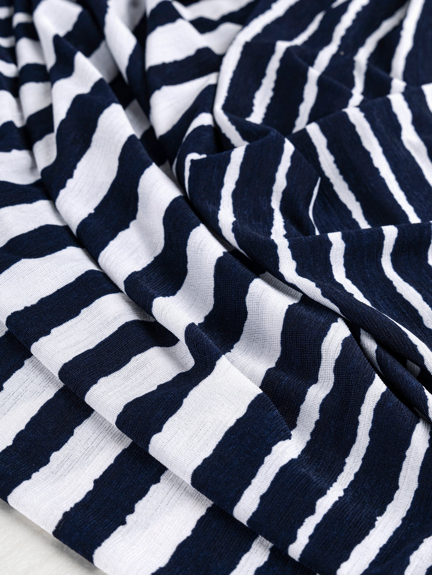 F-DEA024-Brush-Stripe-Poly-Stretch-Knit-Deadstock-Navy-and-White-Core-Fabrics-scrunched.JPG