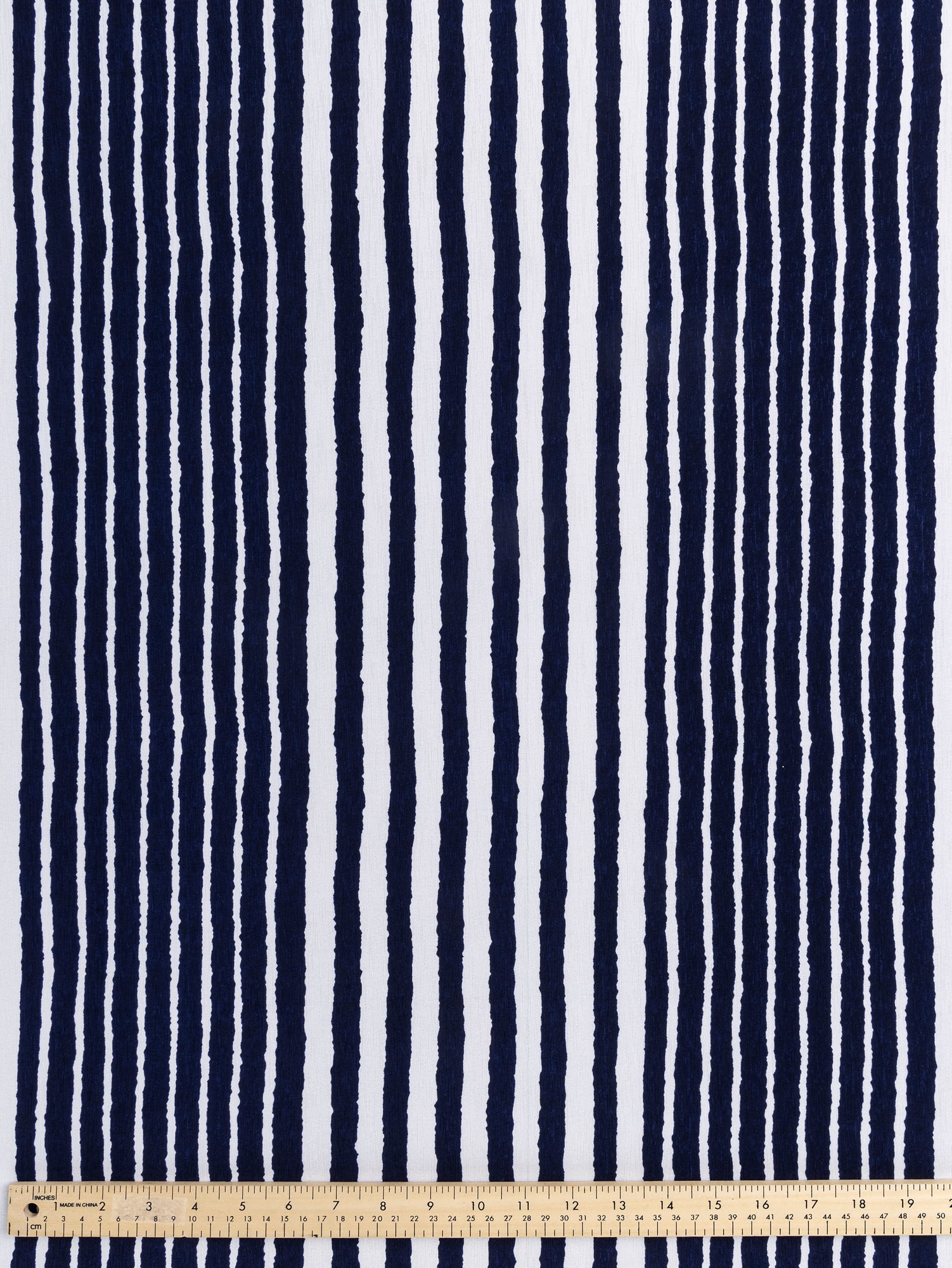 F-DEA024-Brush-Stripe-Poly-Stretch-Knit-Deadstock-Navy-and-White-Core-Fabrics-ruler.JPG