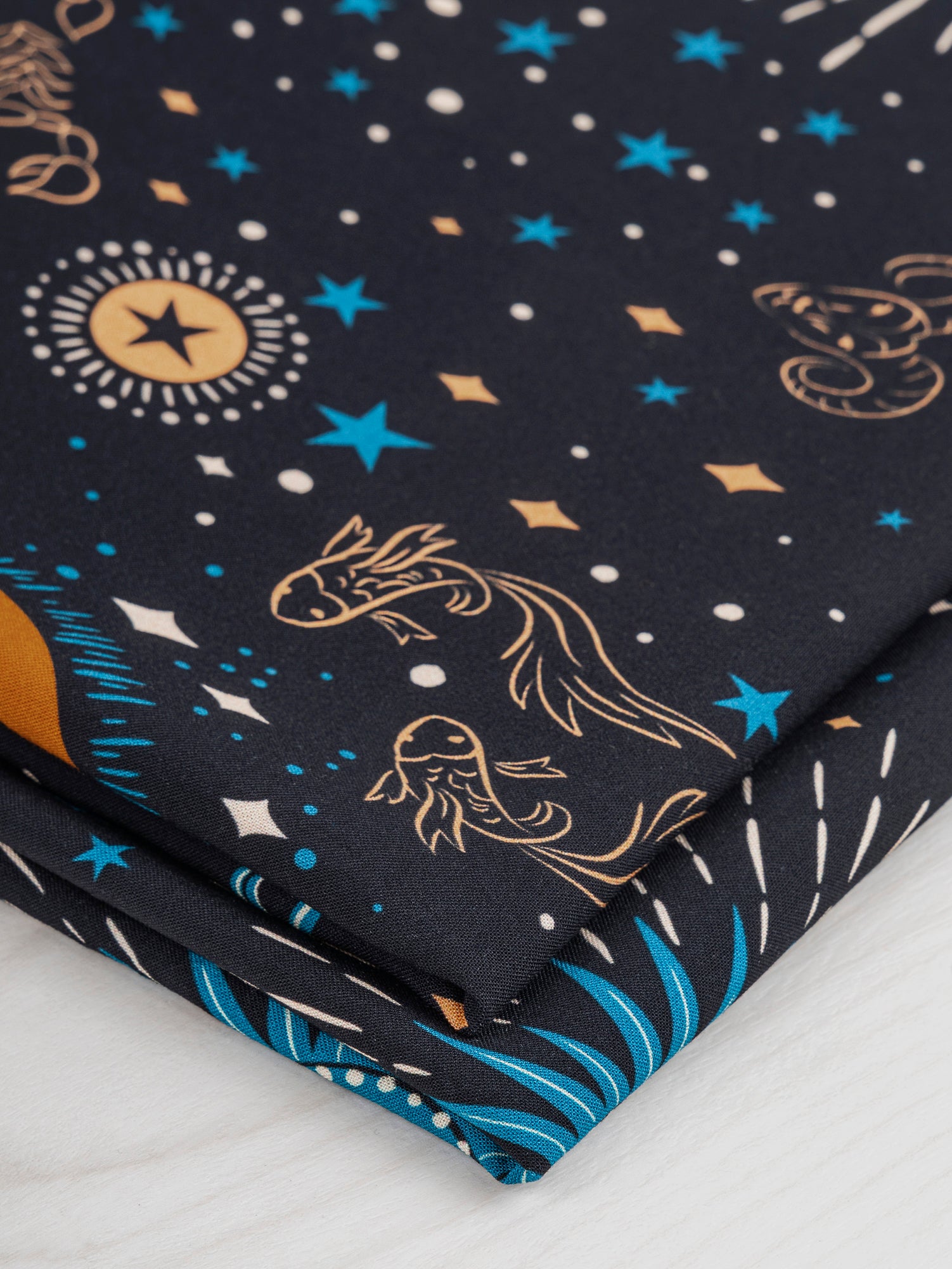 F-VIS229-Celestial-Zodiac-Print-Ecovero-Viscose-Black-Blue-Cream-Ochre-Core-Fabrics-fold