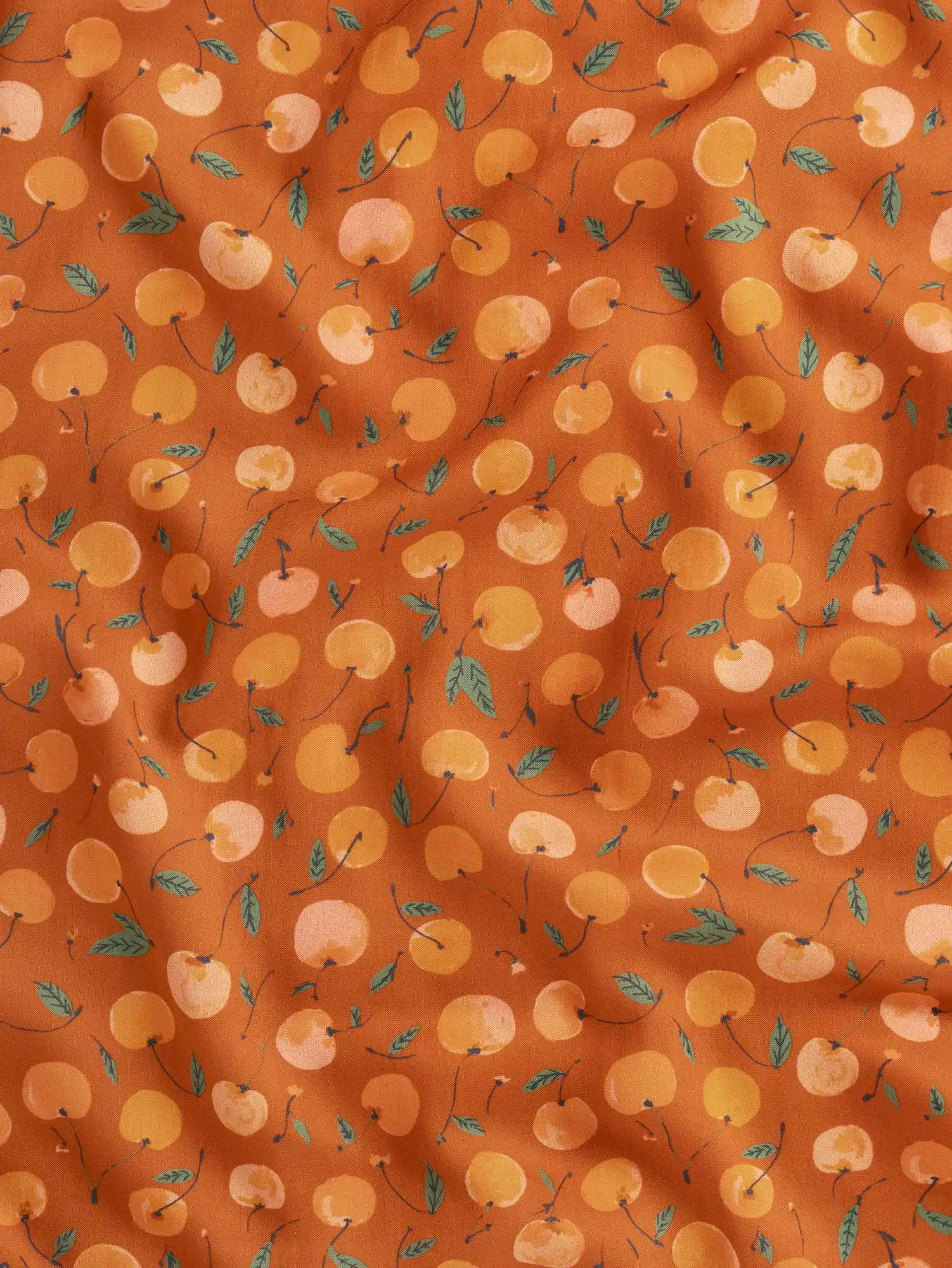 F-DEA237-Cherry-Print-Modal-Challis-Deadstock-Terracotta-Apricot-and-Basil-Core-Fabrics-scrunched.webp