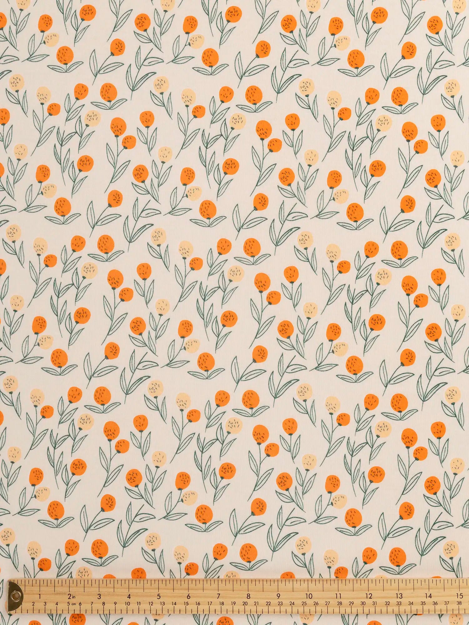 F-DEA236-Clementine-Print-Cotton-Jersey-Deadstock-Oat-Orange-and-Forest-Core-Fabrics-ruler.webp