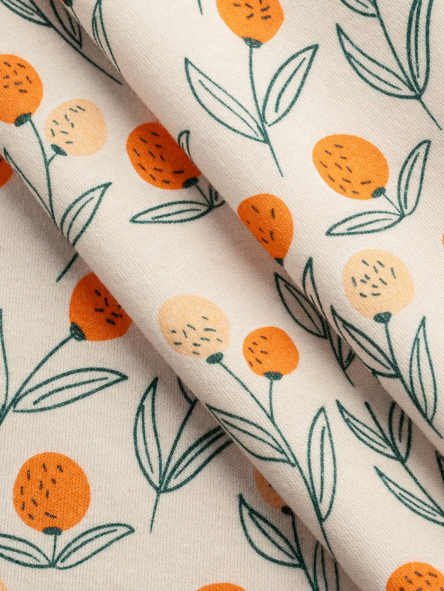 F-DEA236-Clementine-Print-Cotton-Jersey-Deadstock-Oat-Orange-and-Forest-Core-Fabrics-fold.webp