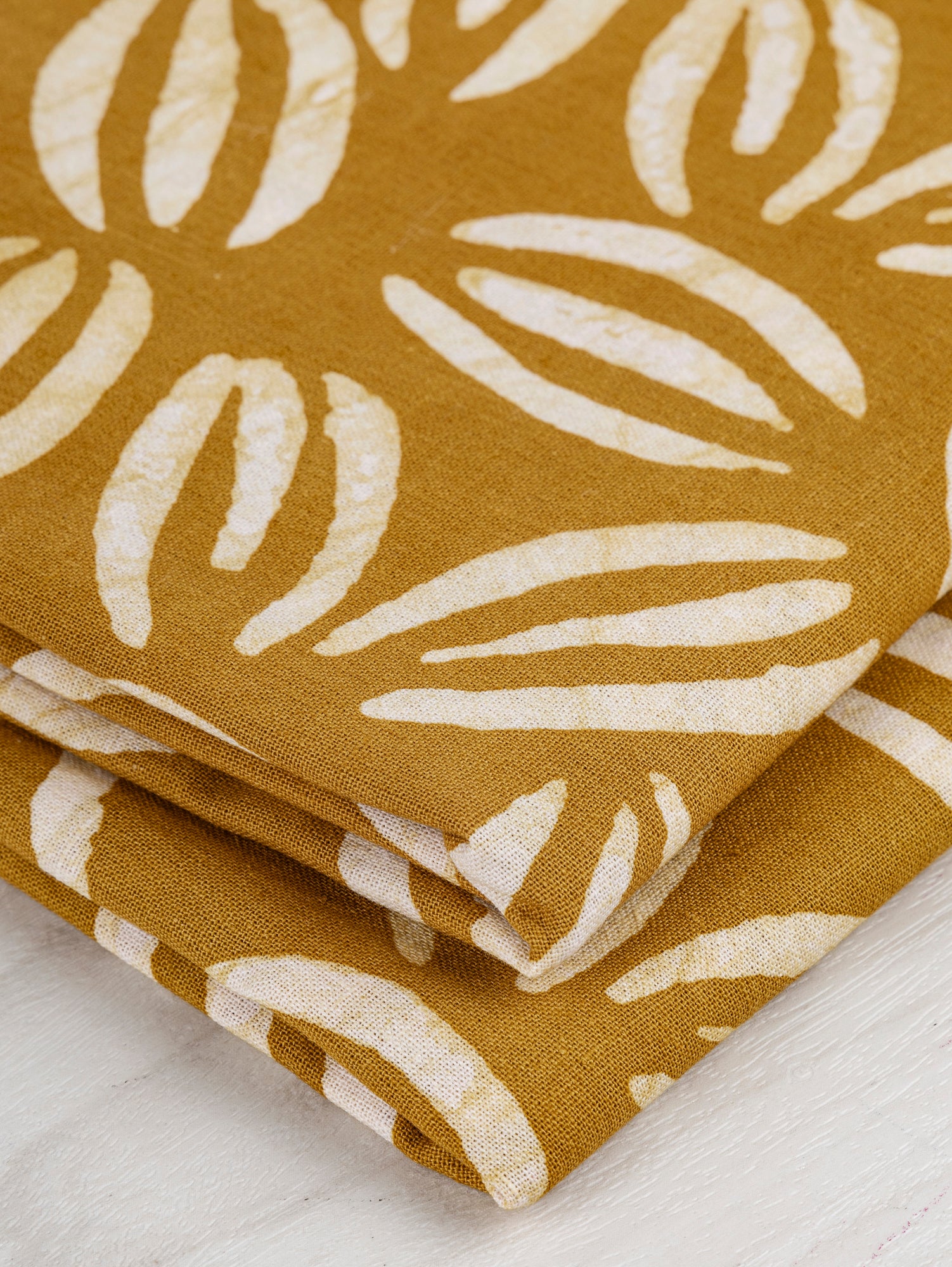 F-COT319-Coffee-Bean-Artisanal-Cotton-Batik-Ochre-White-Core-Fabrics-fold