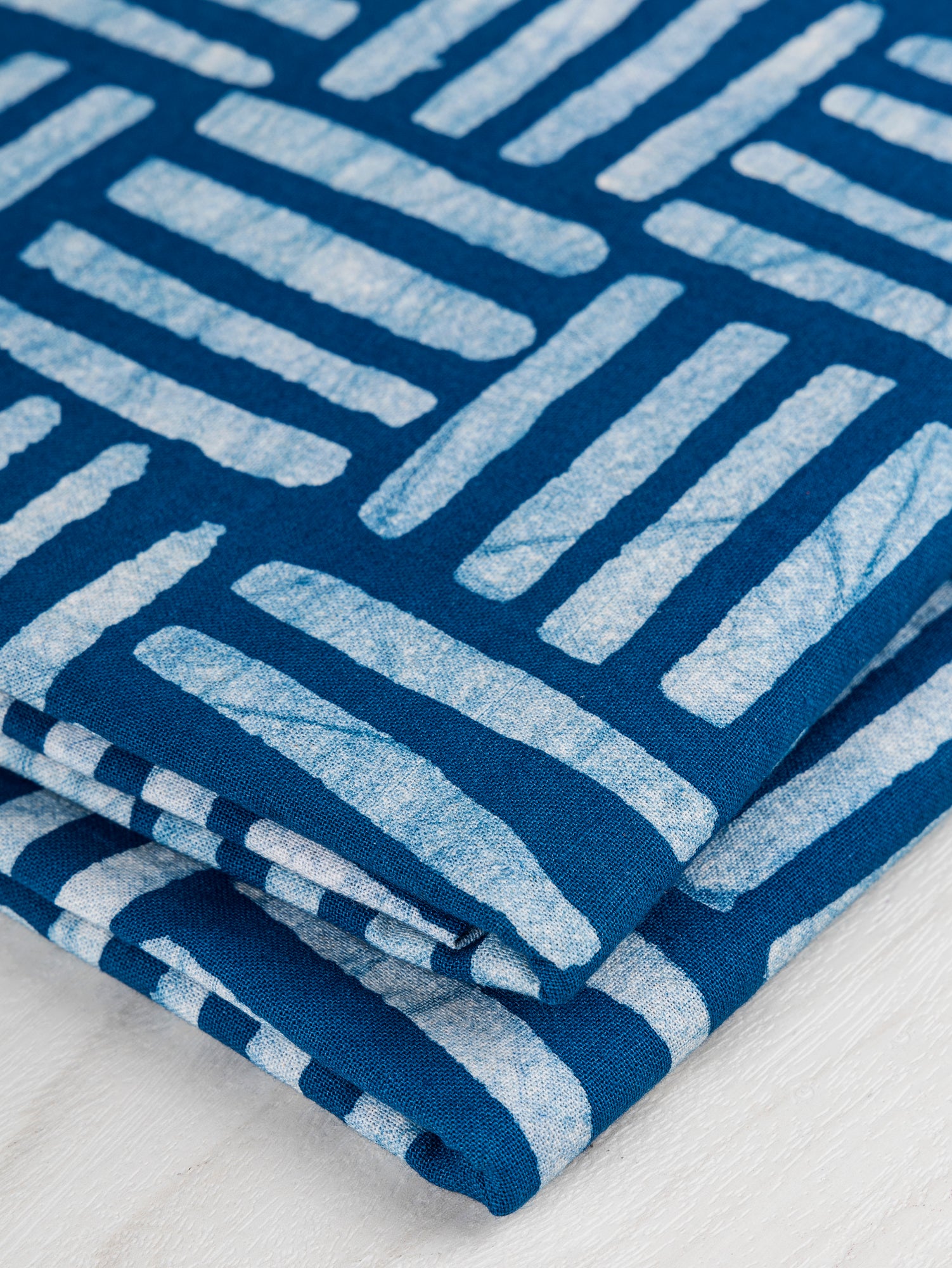 F-COT322-Crossgrid-Artisanal-Cotton-Batik-Teal-White-Core-Fabrics-fold