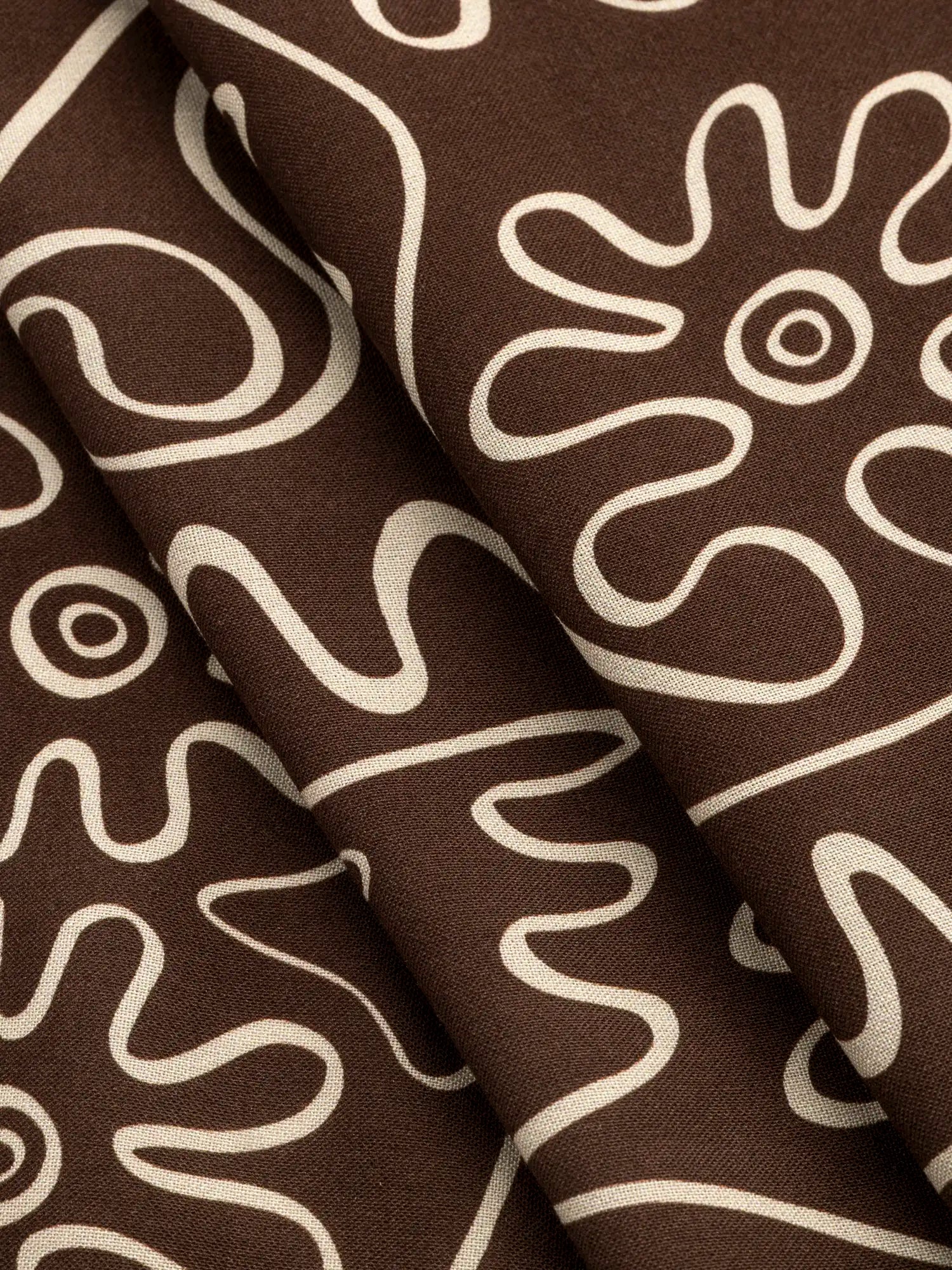 F-VIS302-Curly-Wurly-Print-Ecovero-Viscose-Chocolate-and-Cream-Core-Fabrics-fold.webp