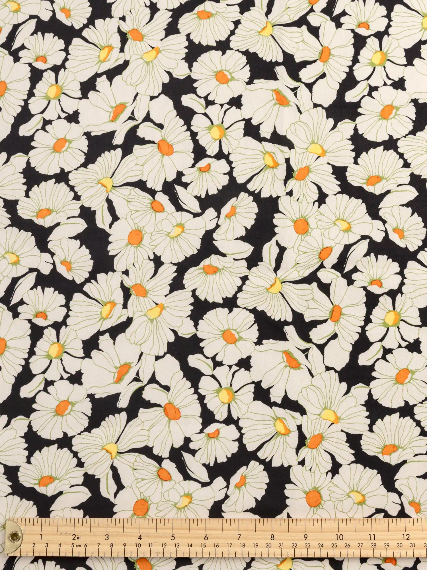F-COT439-Daisy-Print-BCI-Cotton-Lawn-Black-Cream-and-Orange-Core-Fabrics-ruler.webp