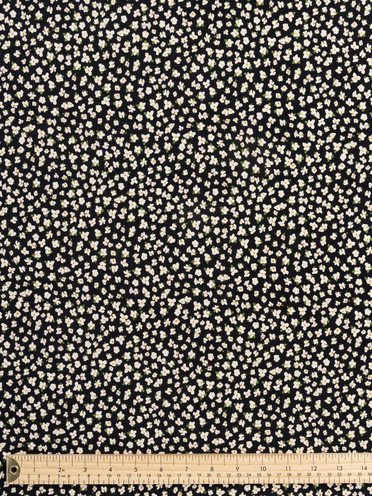 F-VIS306-Ditzy-Daisy-Print-Viscose-Crepe-Black-Ivory-and-Olive-Core-Fabrics-ruler.webp