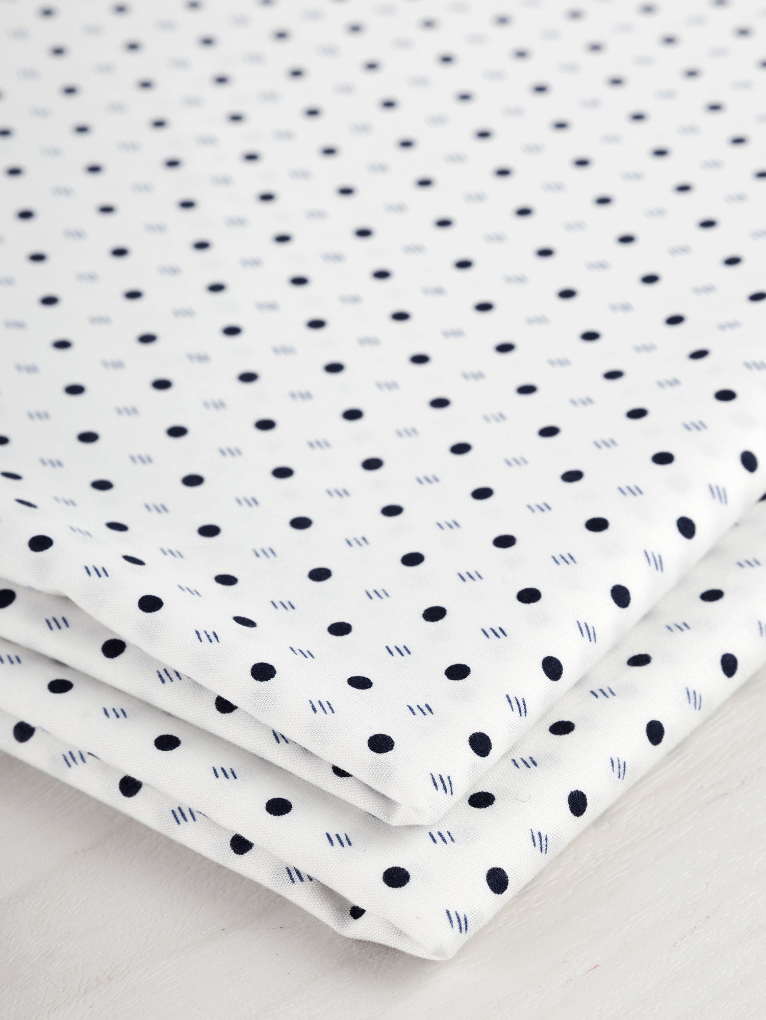 F-DEA035-002-Ditzy-Dot-Stripe-Cotton-Shirting-Deadstock-White-Navy-Core-Fabrics-fold.JPG