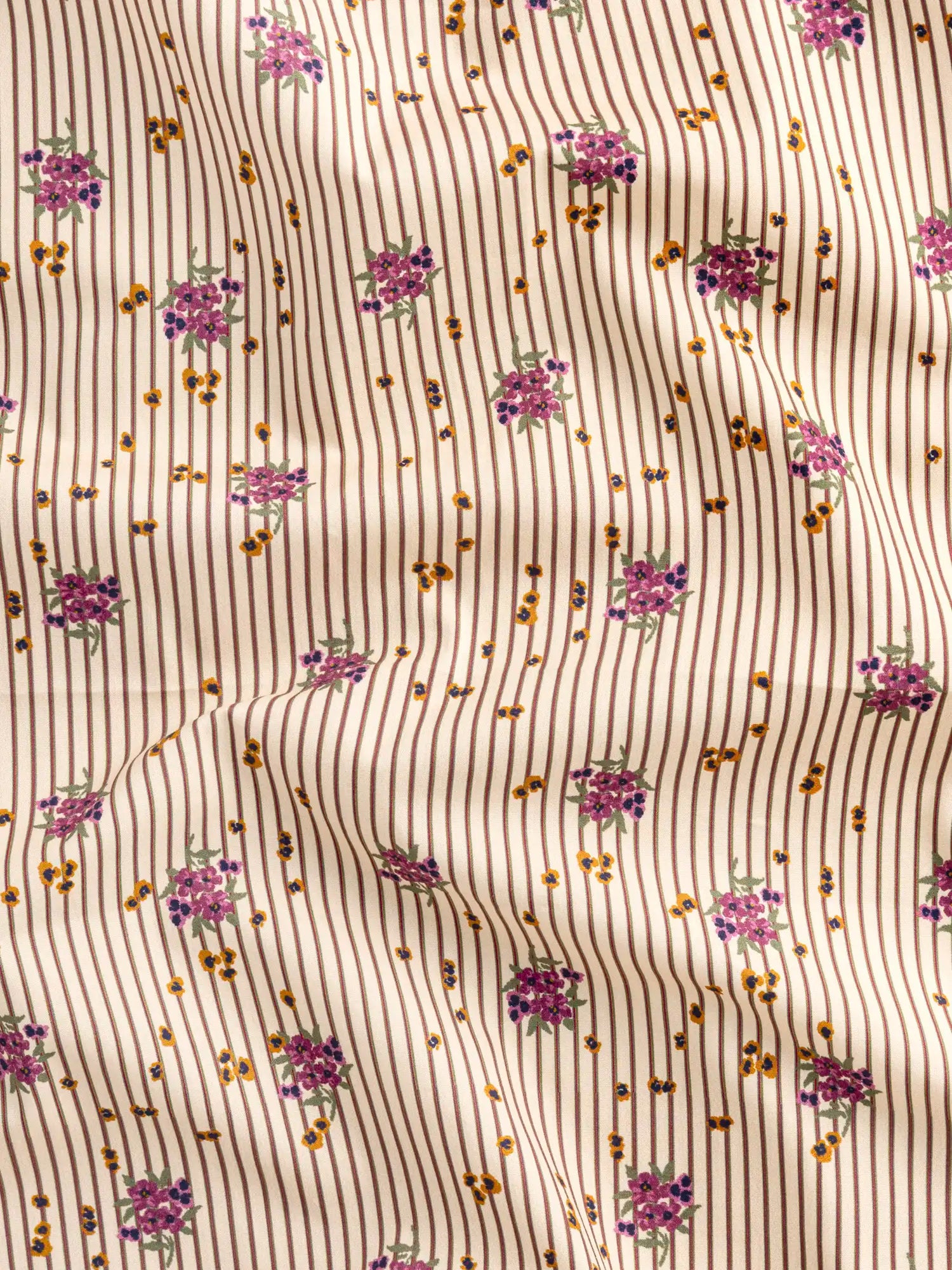 F-COT441-Ditzy-Floral-Stripe-Print-BCI-Cotton-Poplin-Beige-Brown-and-Purple-Core-Fabrics-scrunched.webp
