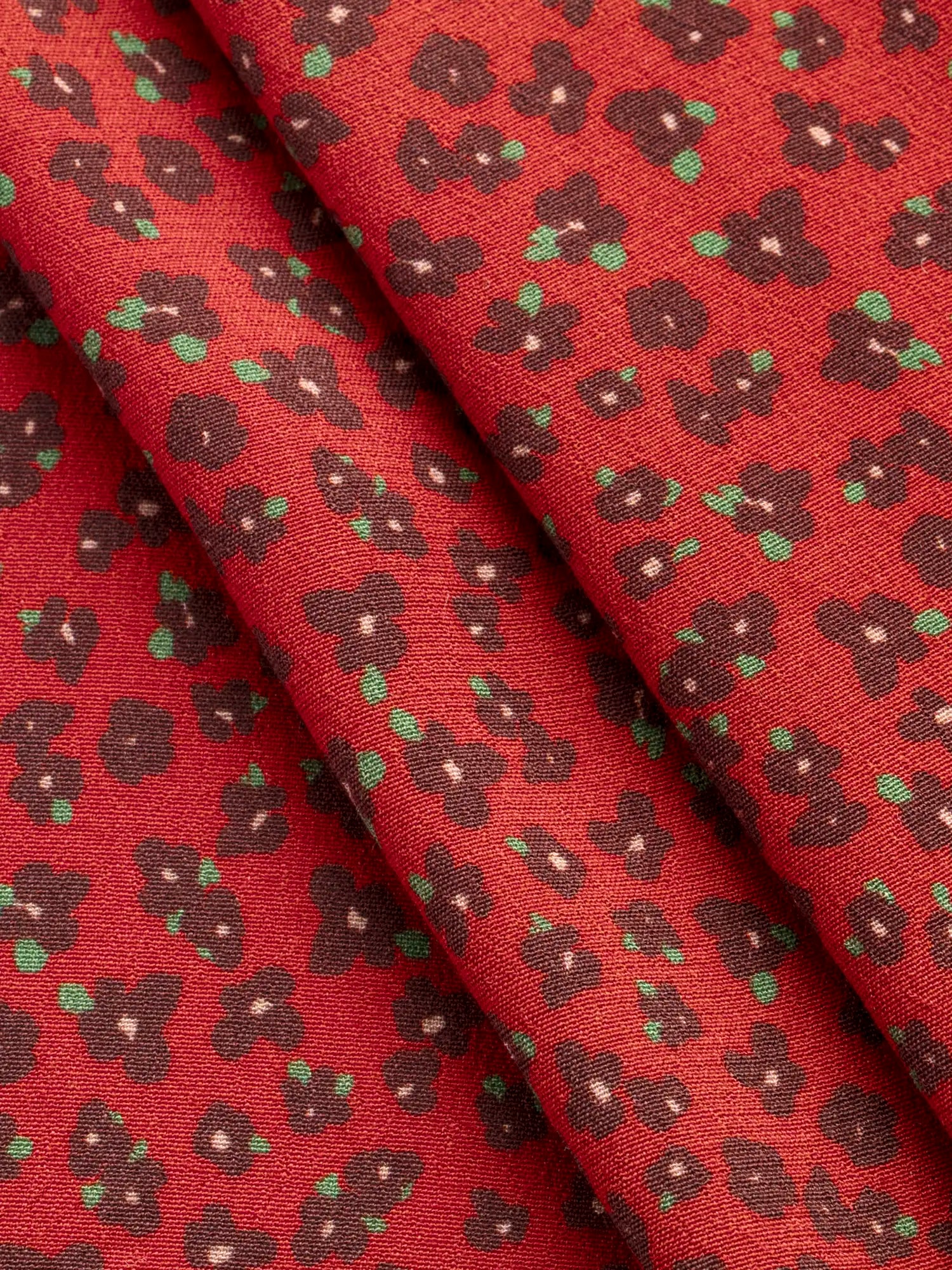 F-VIS297-Ditzy-Flower-Print-Ecovero-Crepe-de-Chine-Ruby-Burgundy-and-Leaf-Core-Fabrics-fold.webp