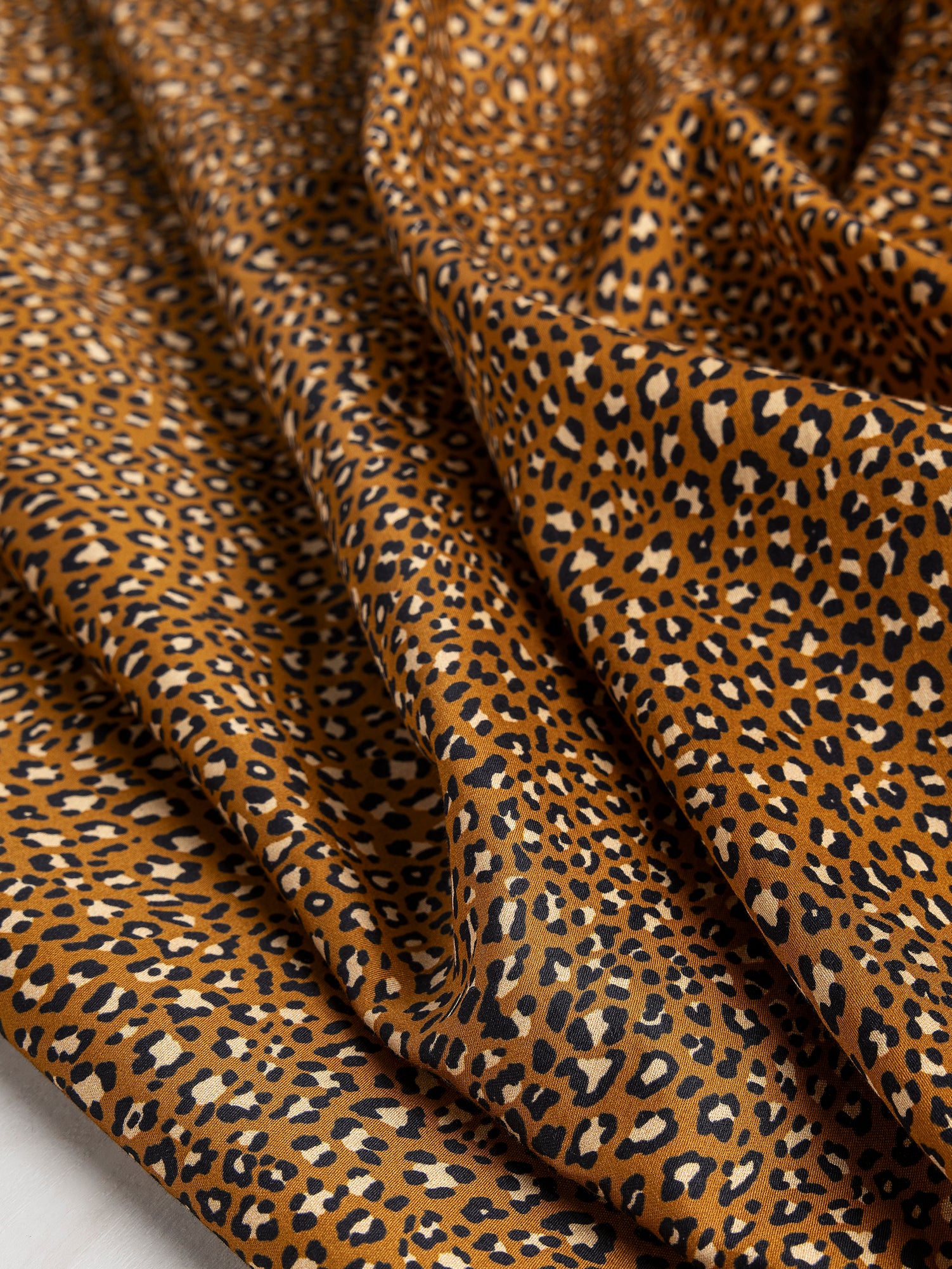 F-COT328-Ditzy-Leopard-Print-Cotton-Lawn-Ochre-Black-Beige-Core-Fabrics-scrunched