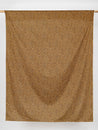 F-COT328-Ditzy-Leopard-Print-Cotton-Lawn-Ochre-Black-Beige-Core-Fabrics-draped