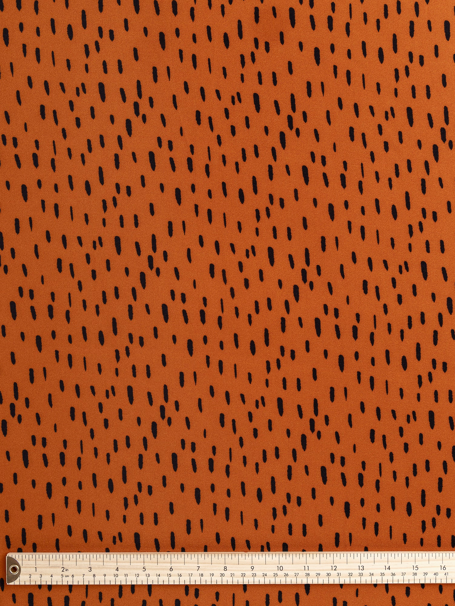 F-VIS257-Drop-Print-Viscose-Crepe-Terracotta-Black-Core-Fabrics-ruler.JPG