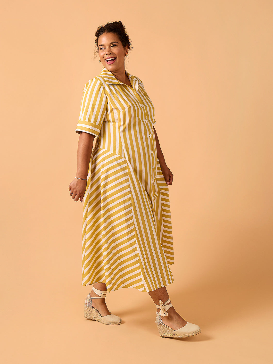 Woman wearing a yellow and white striped dress Edith Dress Sewing Pattern