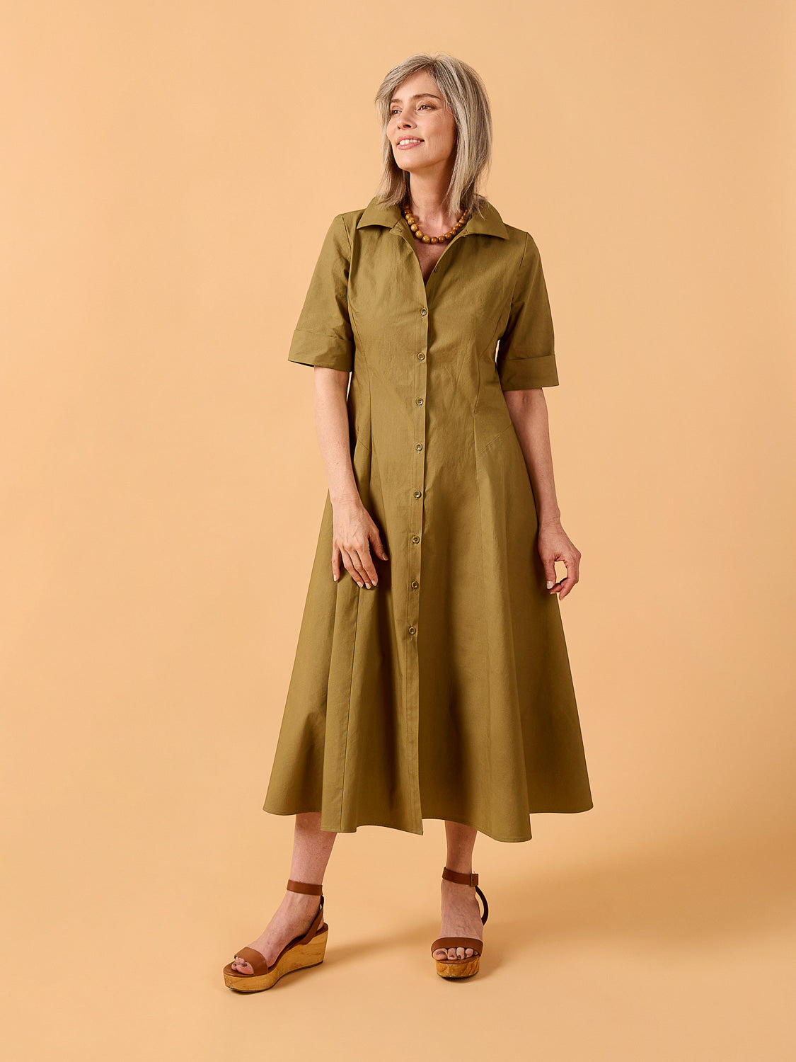 Woman wearing a green dress Edith Dress Sewing Pattern
