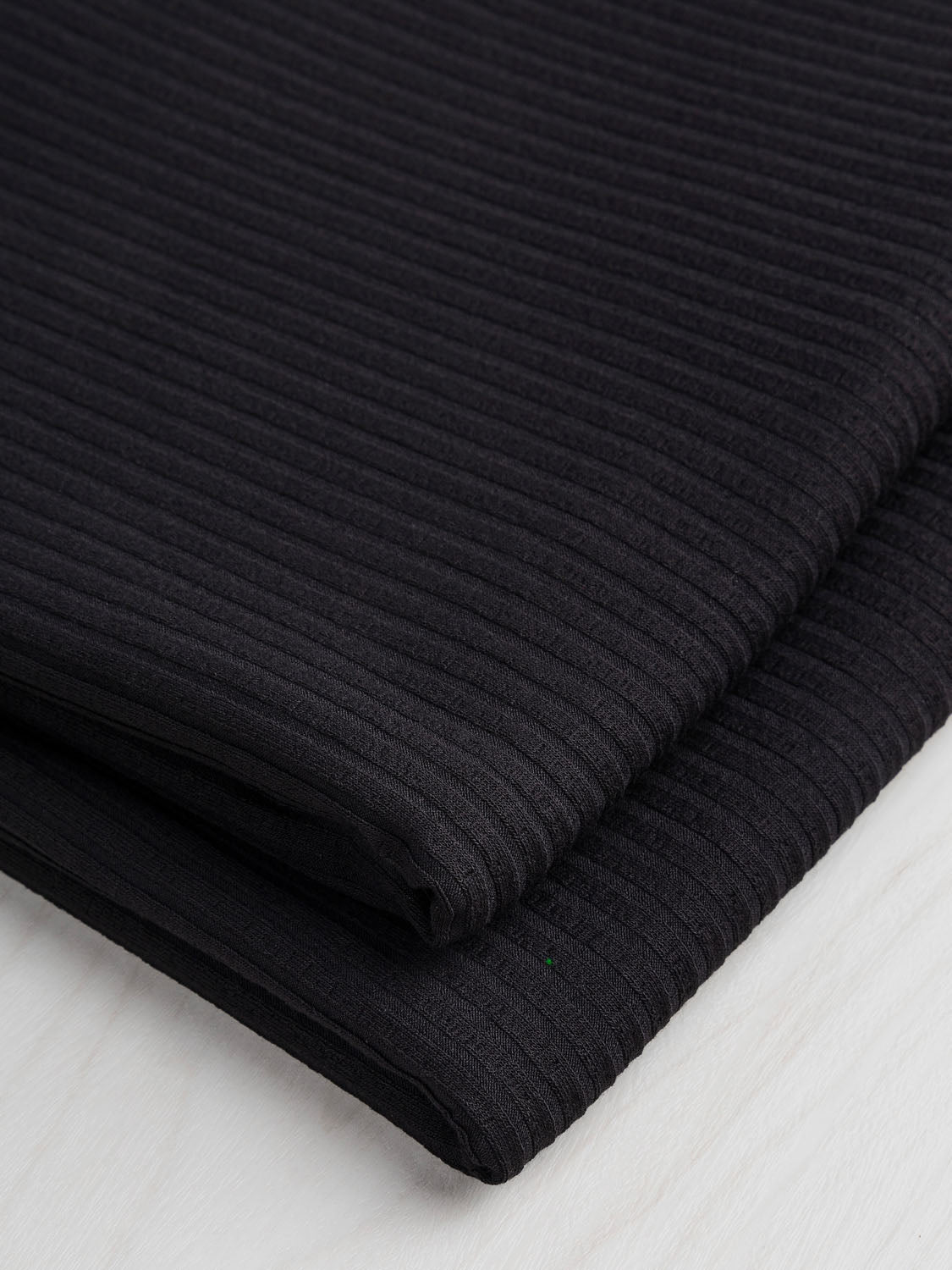 F-VIS150-001-Wide-Rib-EcoVero-Viscose-Knit-Black-Core-Fabrics-fold.jpg