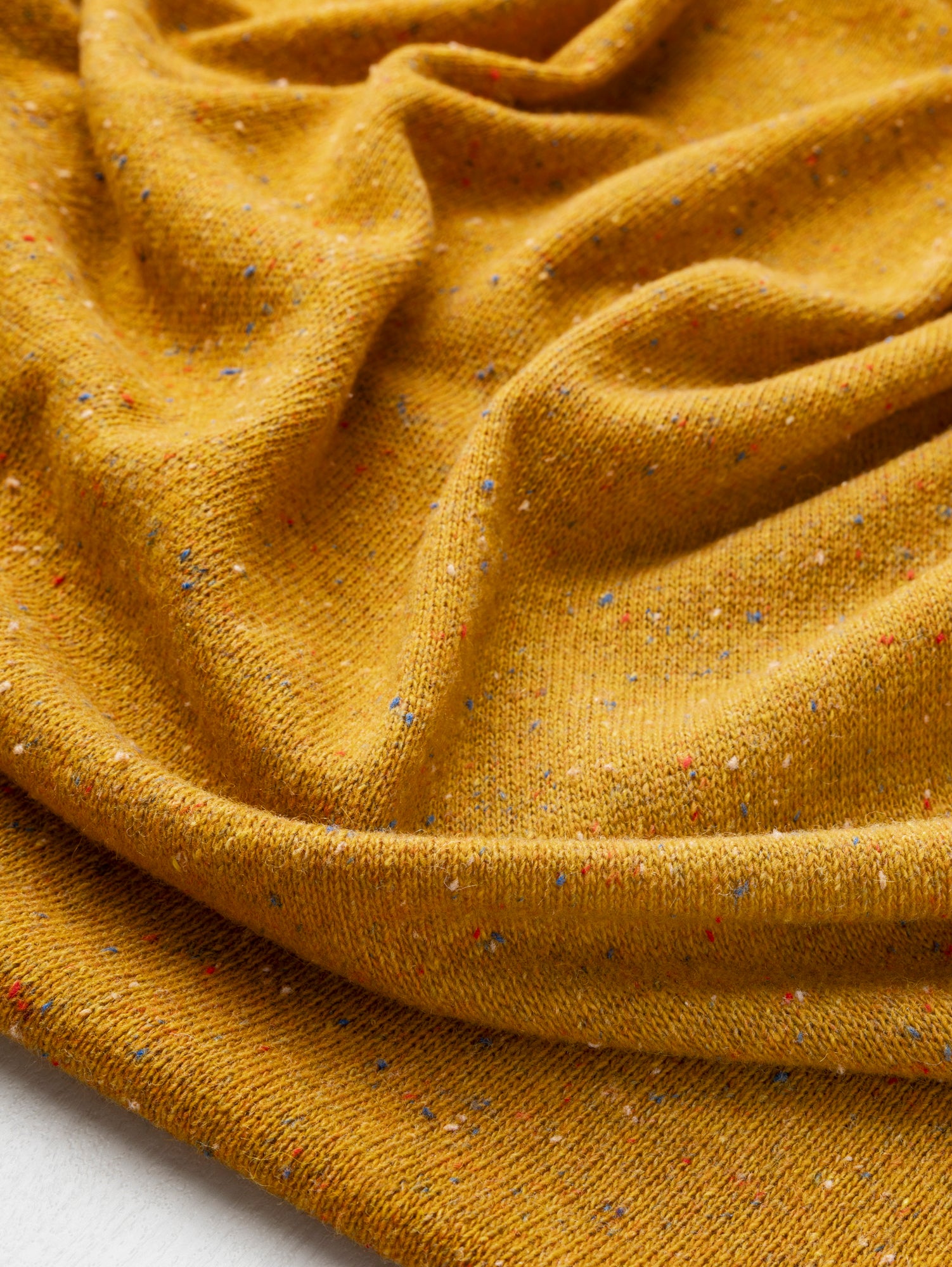 F-WOL144-001-Fleck-Italian-Wool-Silk-Sweater-Knit-Mustard-Core-Fabrics-scrunched.JPG