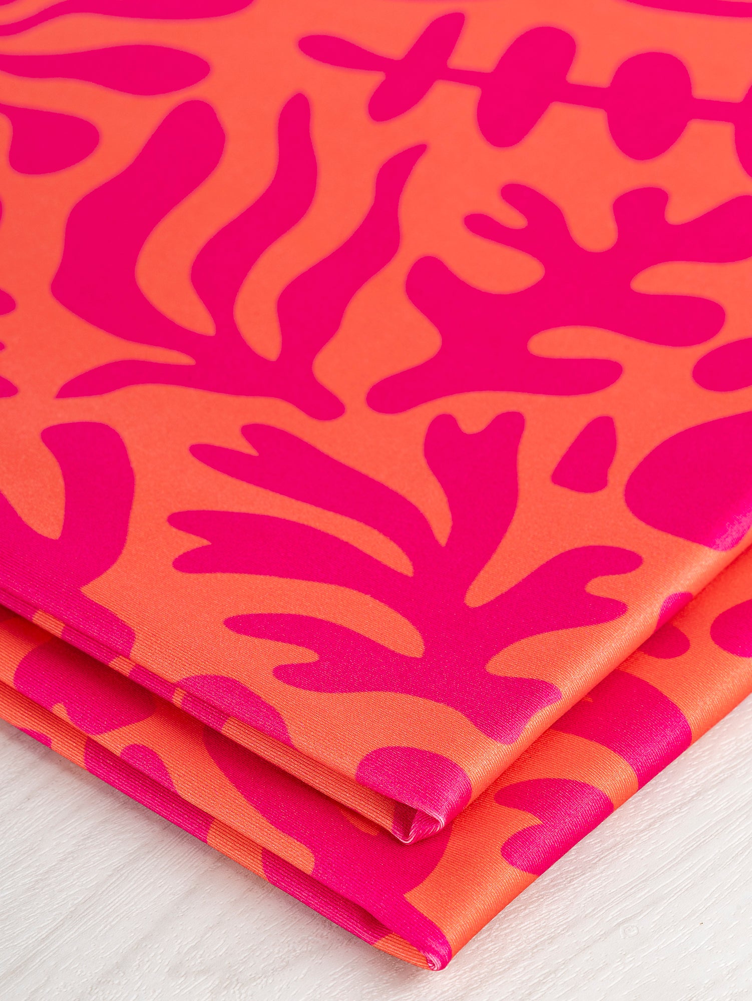 F-PES036-002-Floral-Cut-Out-Print-Recycled-Swim-Performance-Knit-Orange-Raspberry-Core-Fabrics-fold.JPG