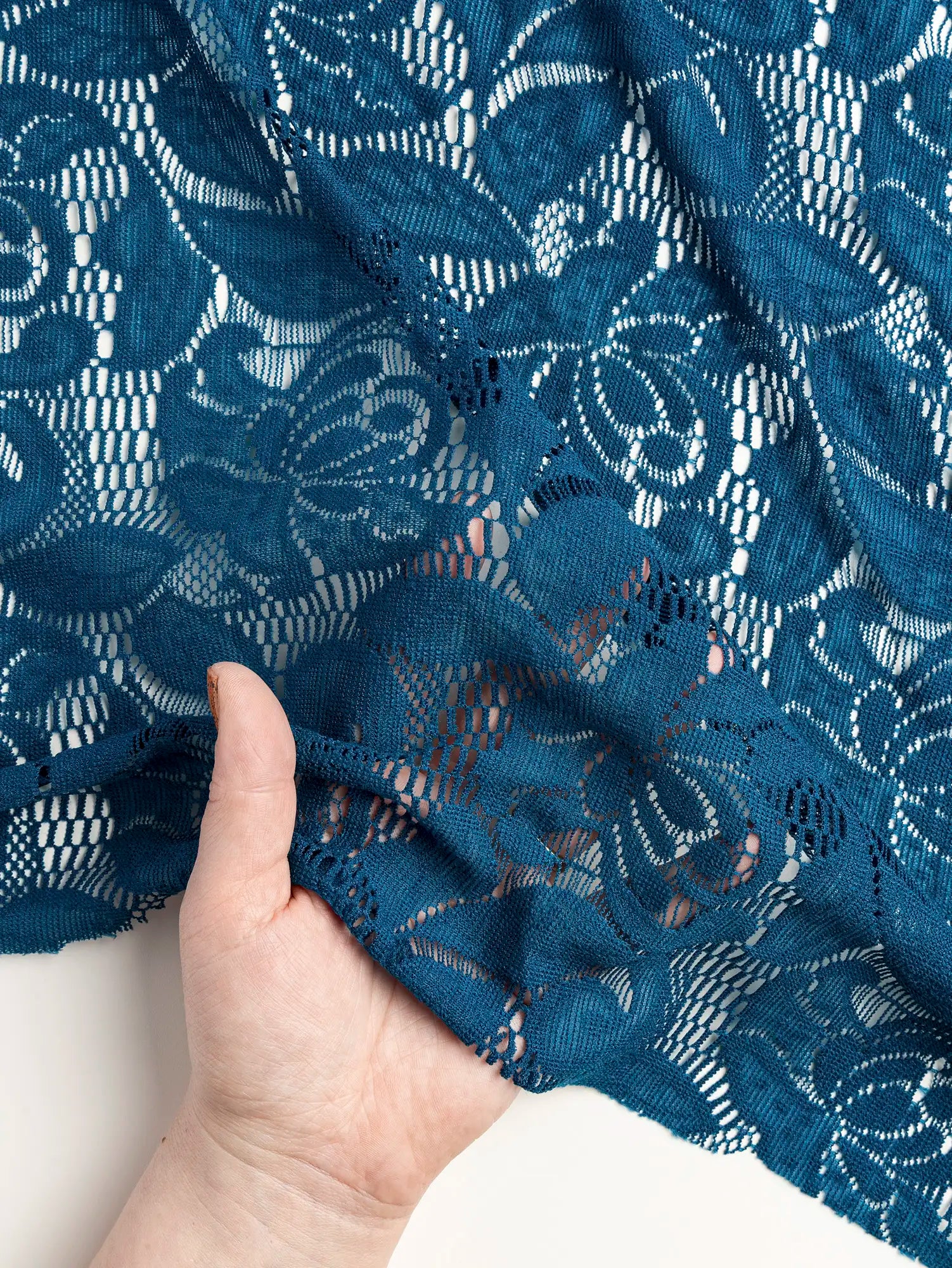 F-DEA185-Floral-Stretch-Lace-Deadstock-Deep-Teal-Core-Fabrics-fold.webp