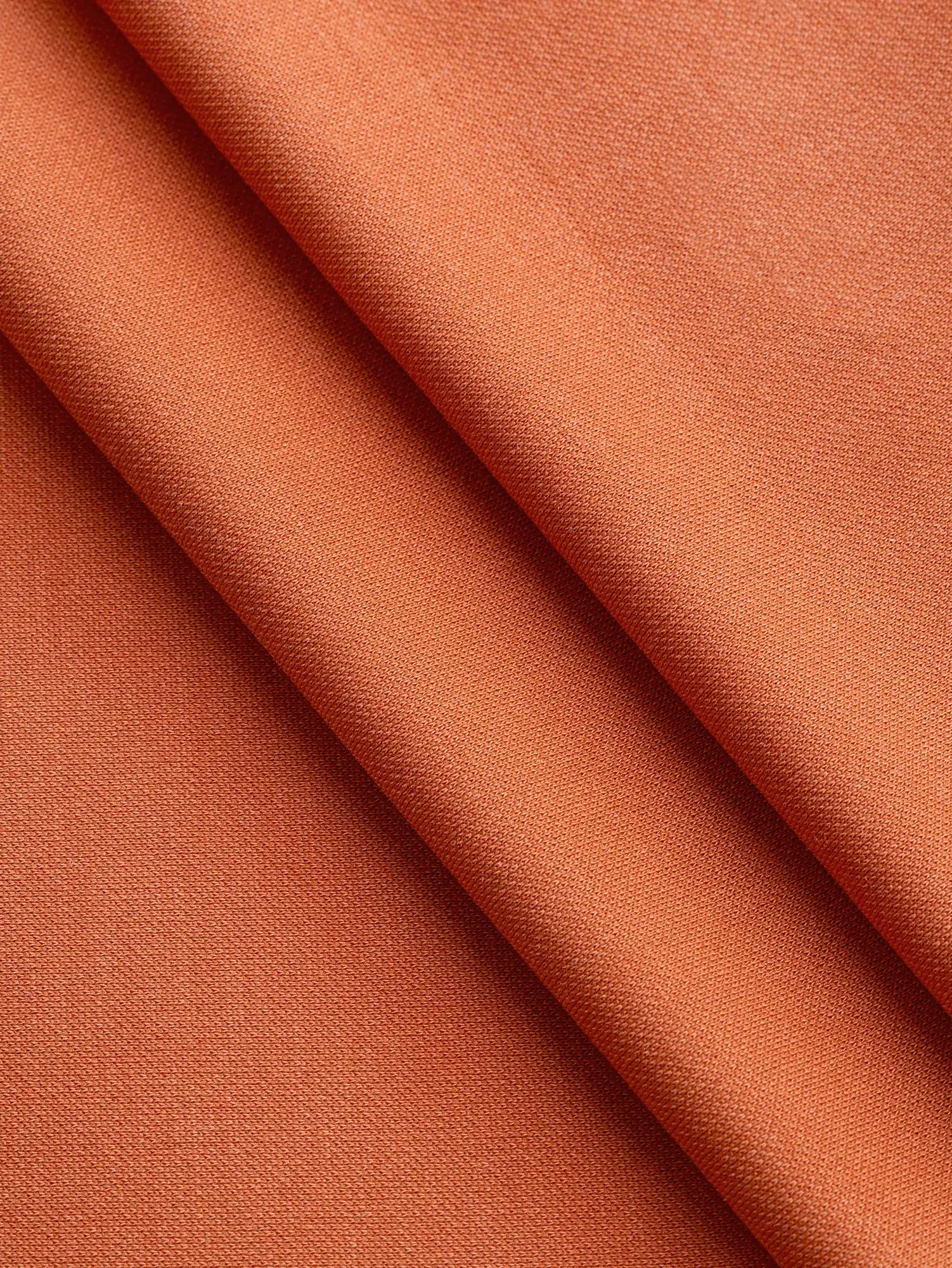 F-DEA233-Fluid-Cotton-Poly-Stretch-Knit-Deadstock-Terracotta-Core-Fabrics-fold.webp