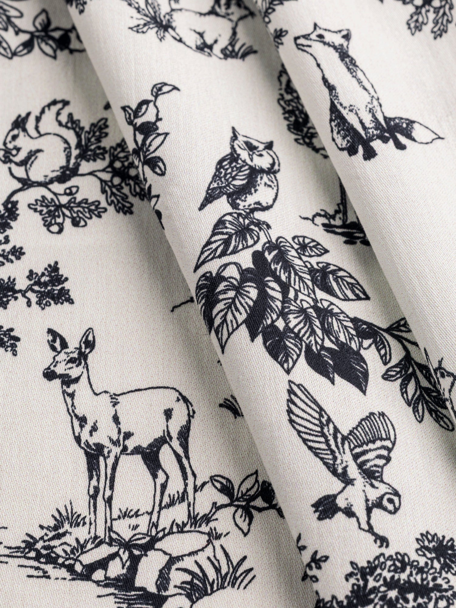 F-COT392-Forest-Friends-Toile-Print-Cotton-Lawn-Cream-Black-Core-Fabrics-fold.JPG