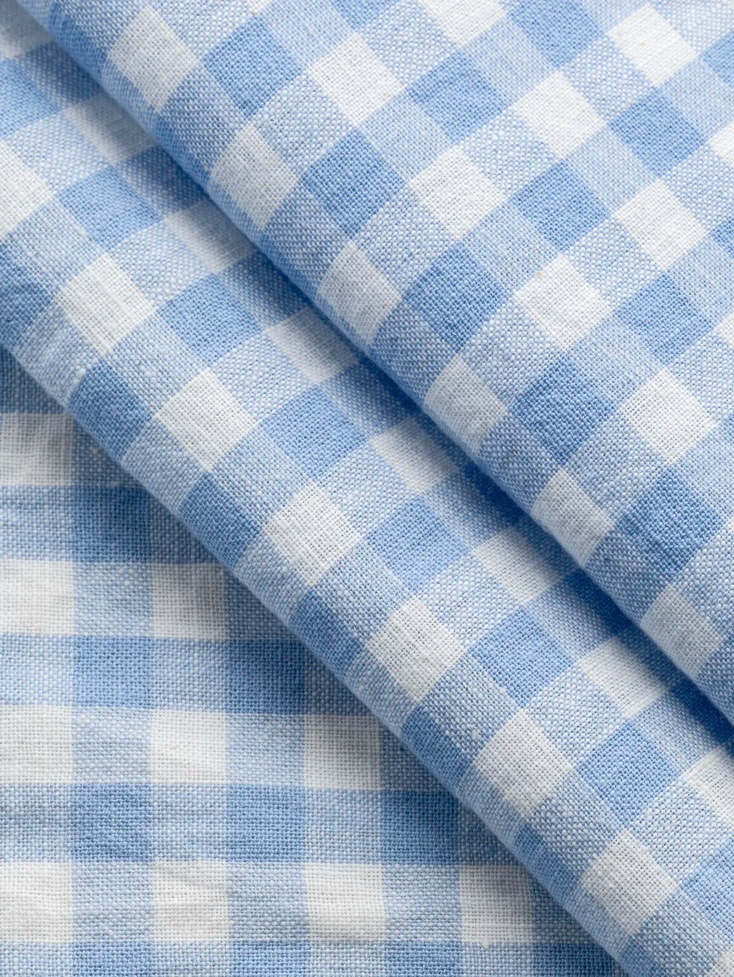 F-COT352-008-Forget-Me-Not-Handwoven-Gingham-Cotton-Chambray-and-Ivory-Core-Fabrics-fold.webp