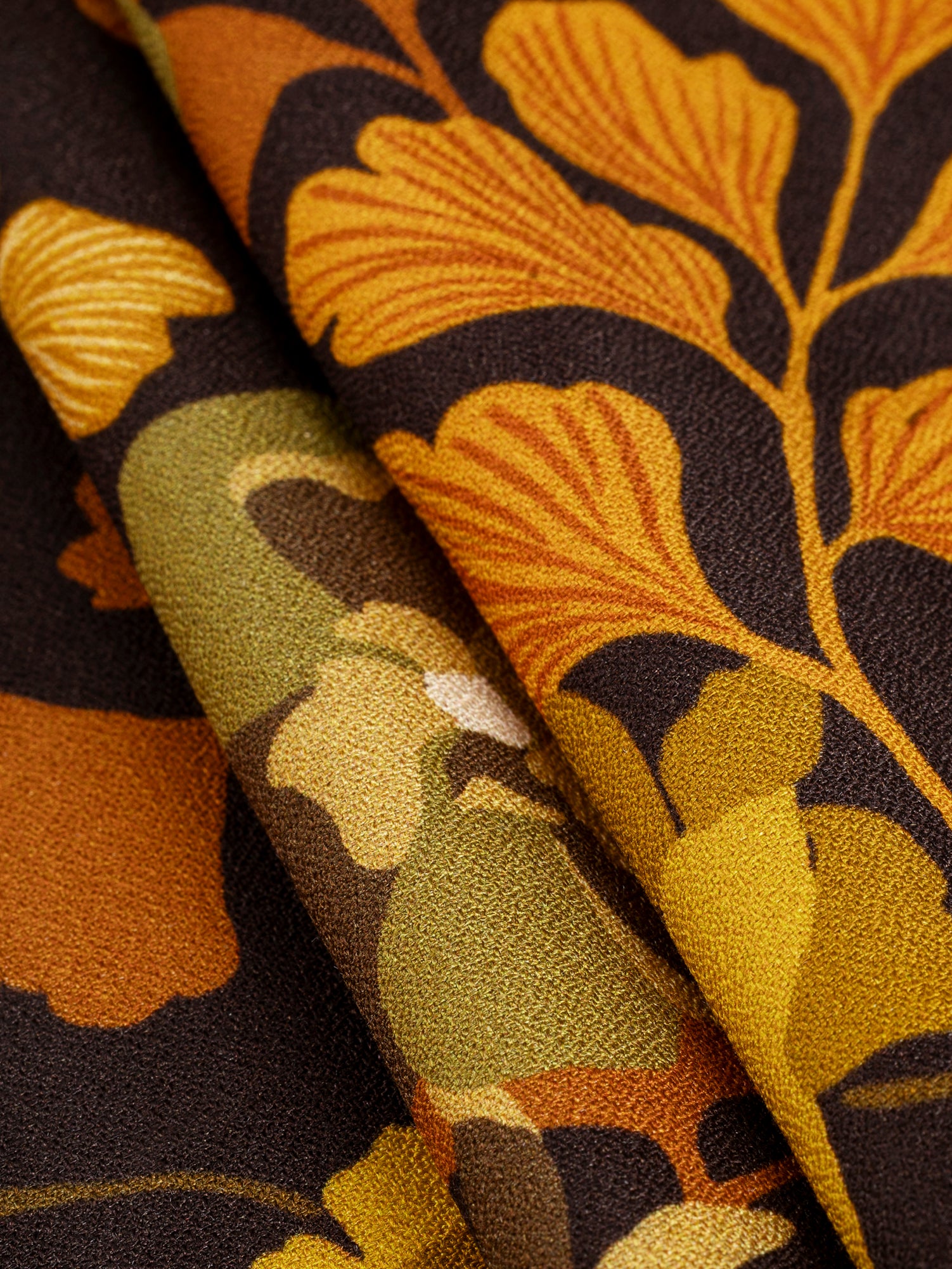 F-VIS258-Ginkgo-Floral-Print-Viscose-Crepe-Dark-Brown-Orange-and-Olive-Core-Fabrics-fold.JPG