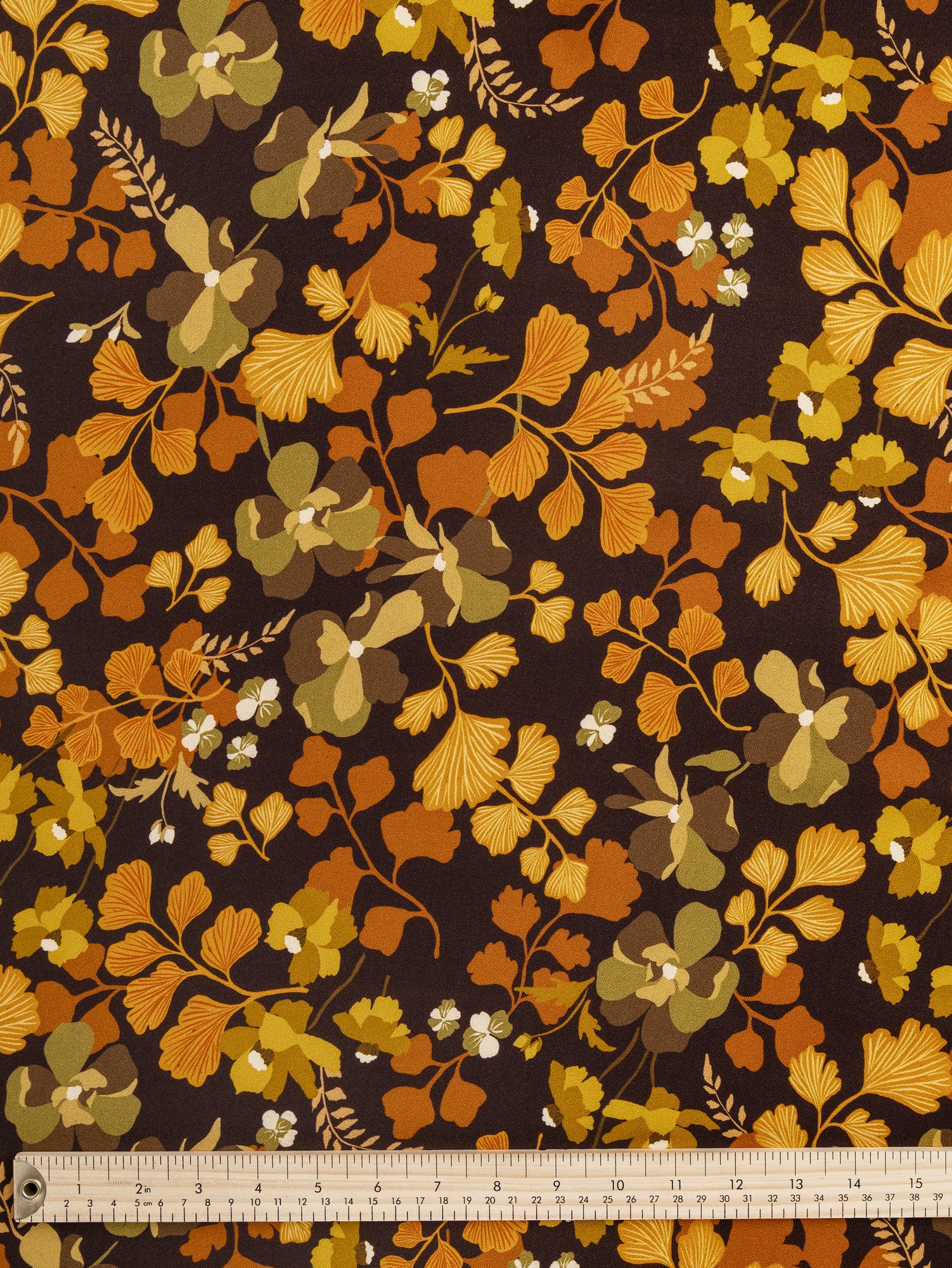 F-VIS258-Ginkgo-Floral-Print-Viscose-Crepe-Dark-Brown-Orange-and-Olive-Core-Fabrics-ruler.JPG