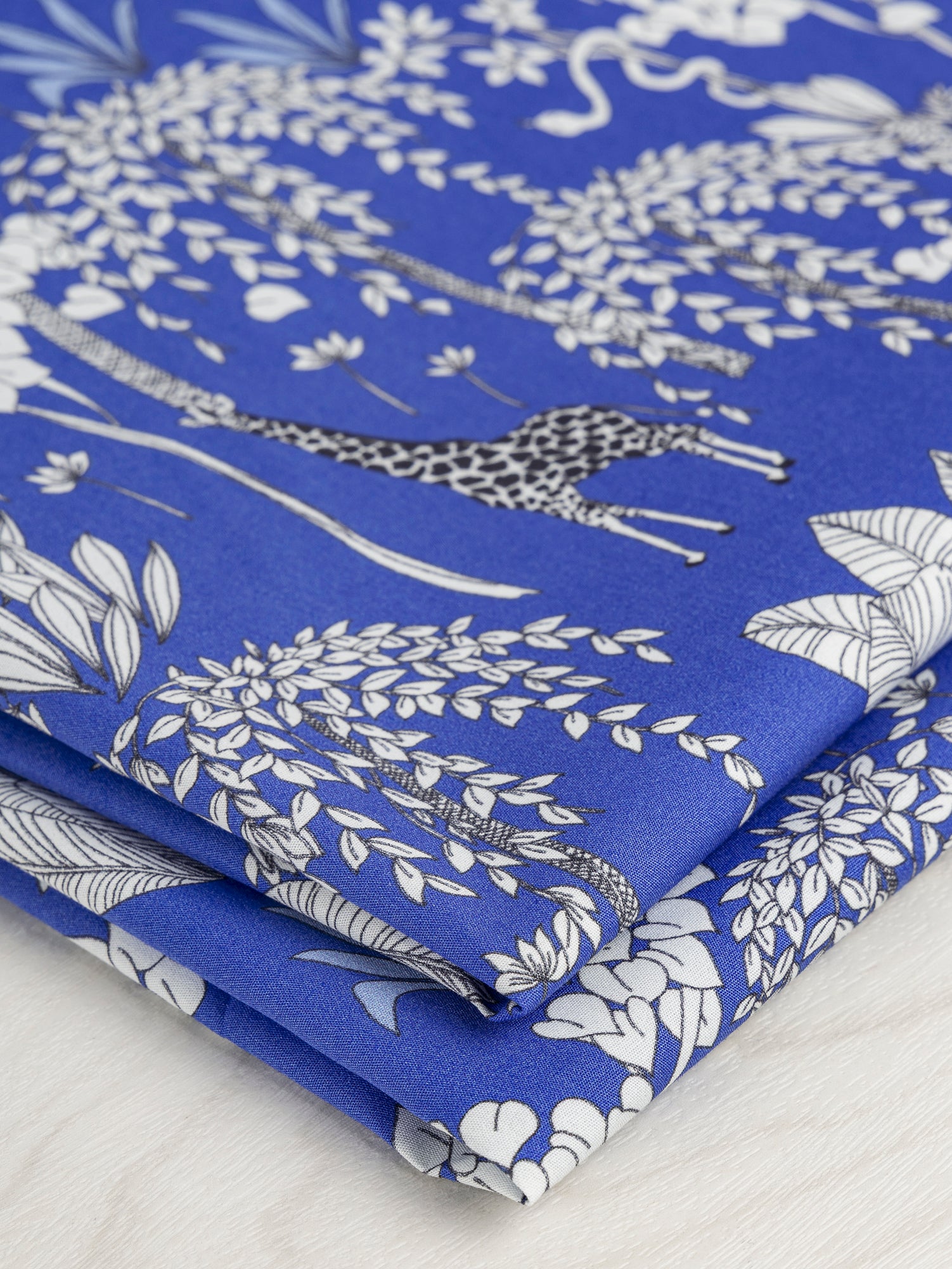 F-COT348-Giraffe-Print-Cotton-Poplin-Blue-Black-and-White-Core-Fabrics-fold.JPG