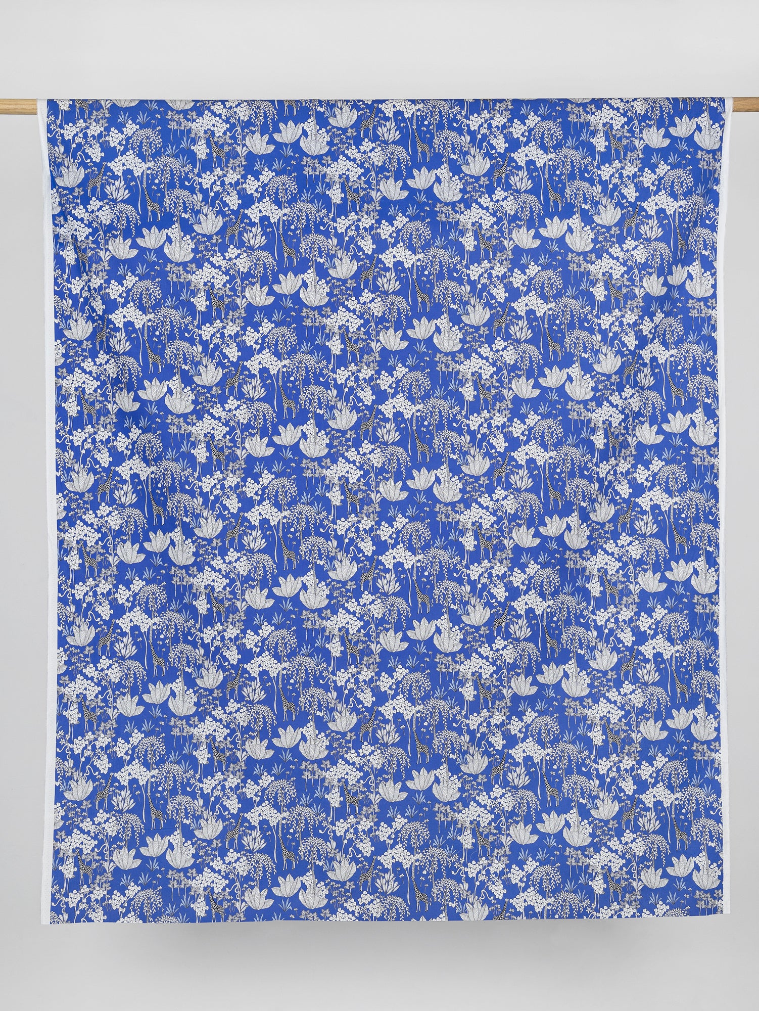 F-COT348-Giraffe-Print-Cotton-Poplin-Blue-Black-and-White-Core-Fabrics-draped.JPG