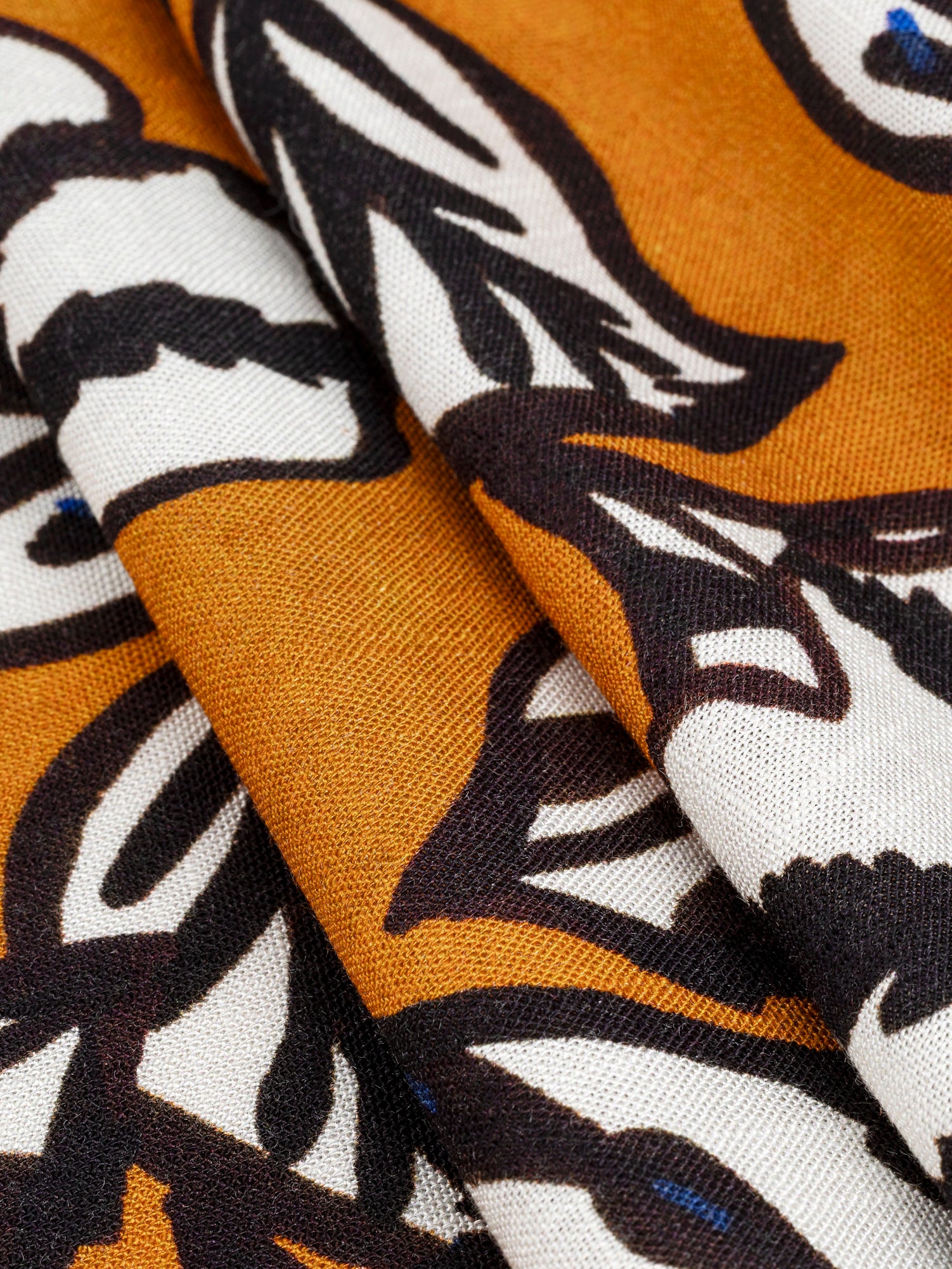 F-VIS256-Graphic-Leaf-Print-Textured-Viscose-Ochre-Black-White-Blue-Core-Fabrics-fold.JPG