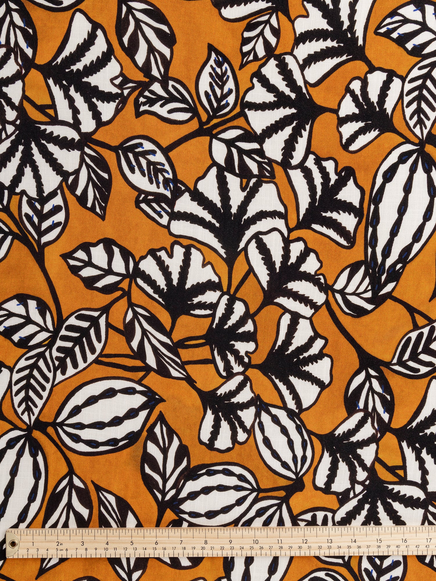 F-VIS256-Graphic-Leaf-Print-Textured-Viscose-Ochre-Black-White-Blue-Core-Fabrics-ruler.JPG