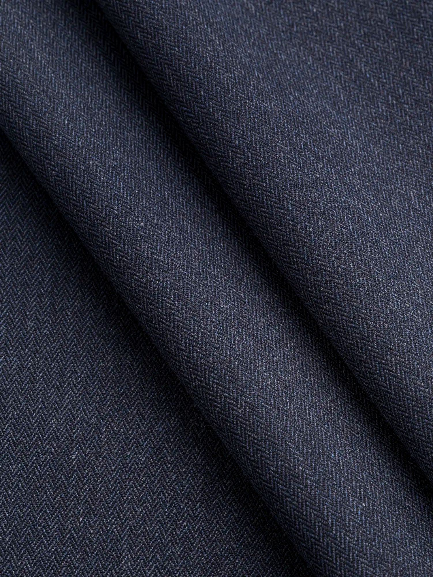 F-WOL156-Herringbone-Wool-Blend-Italian-Stretch-Suiting-Deadstock-Navy-Core-Fabrics-fold.webp