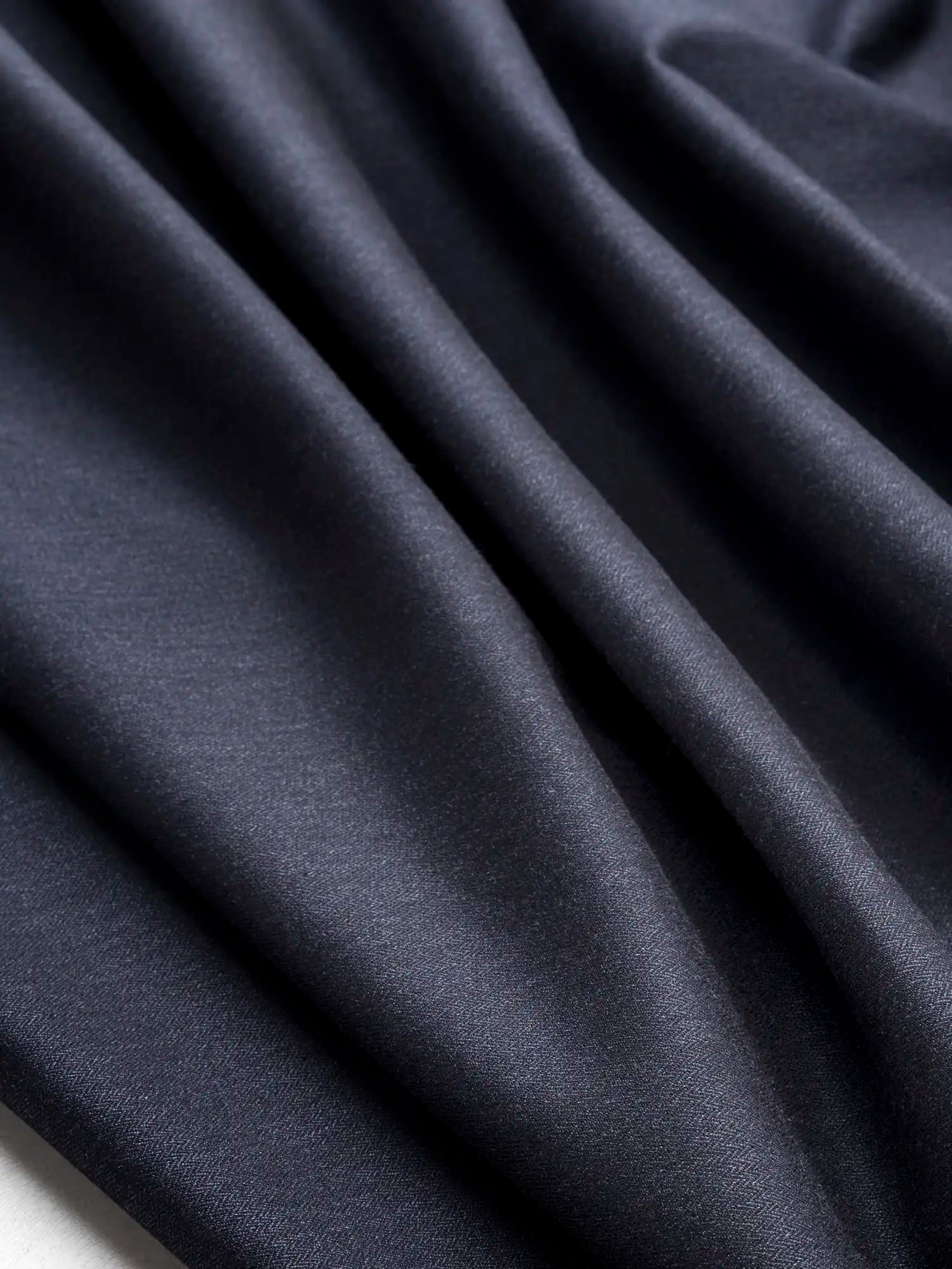 F-WOL156-Herringbone-Wool-Blend-Italian-Stretch-Suiting-Deadstock-Navy-Core-Fabrics-scrunched.webp