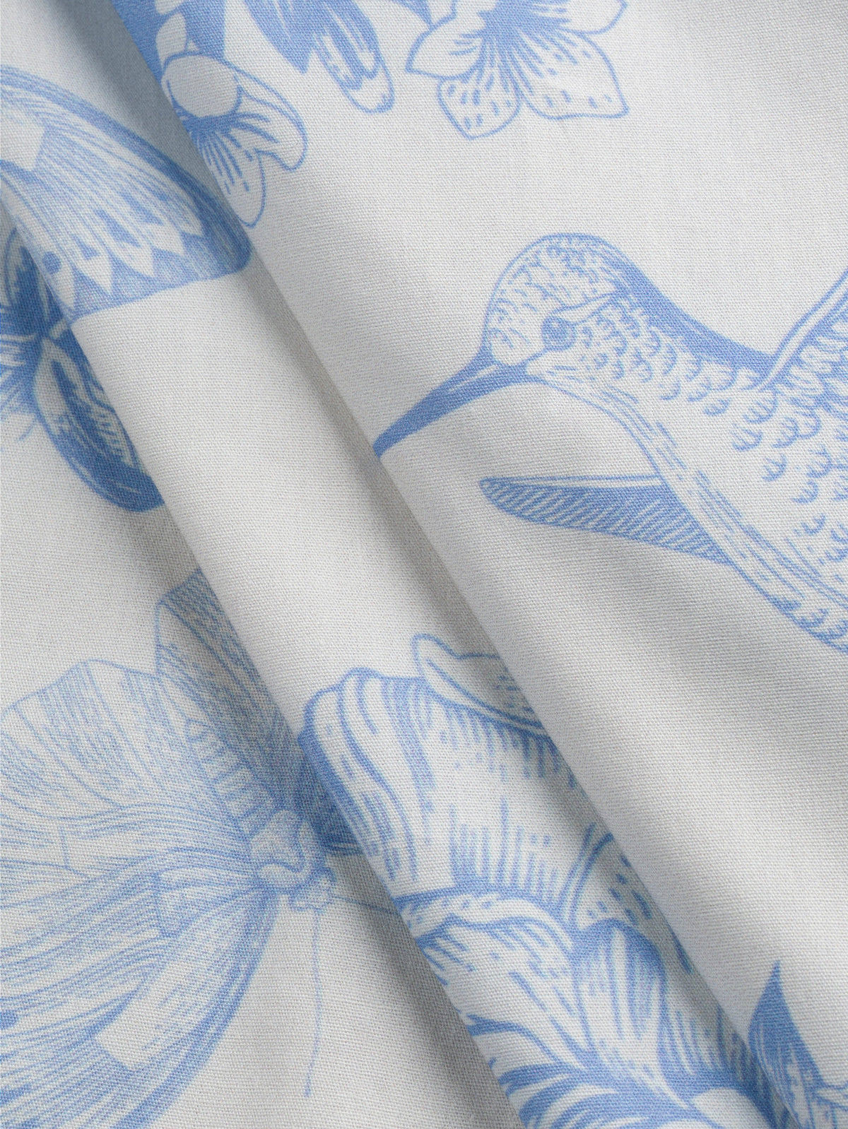 F-COT499-Hummingbird-Toile-de-Jouy-Print-Cotton-Poplin-Ivory-and-Chambray-Core-Fabrics-fold.webp